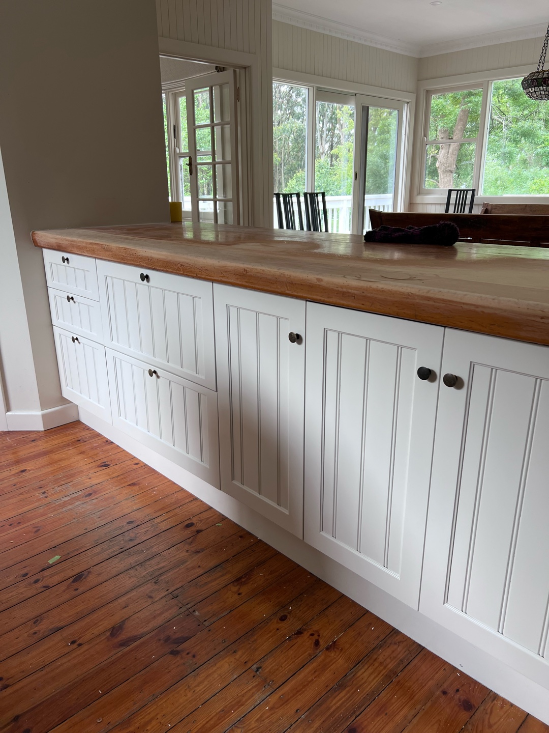 White kitchen cabinets with vertical paneling