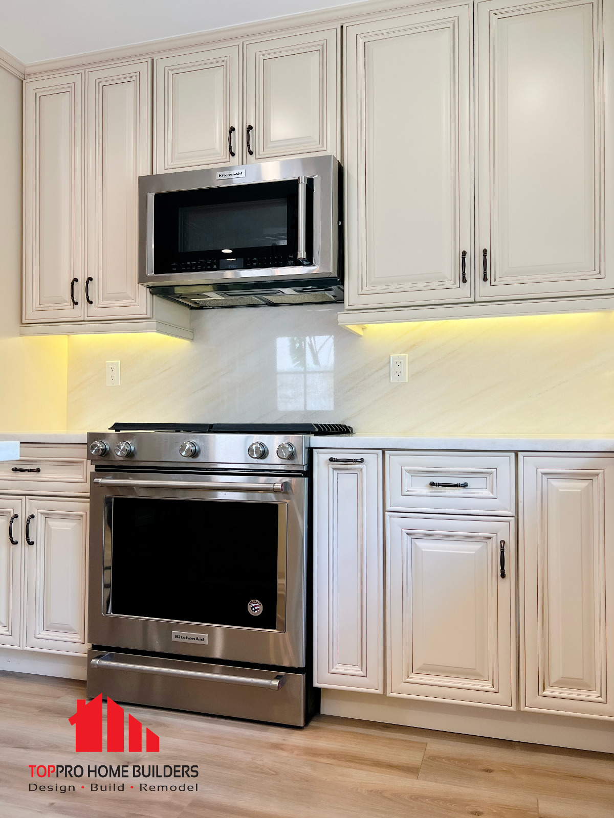 Stainless steel KitchenAid oven with cream-colored cabinetry