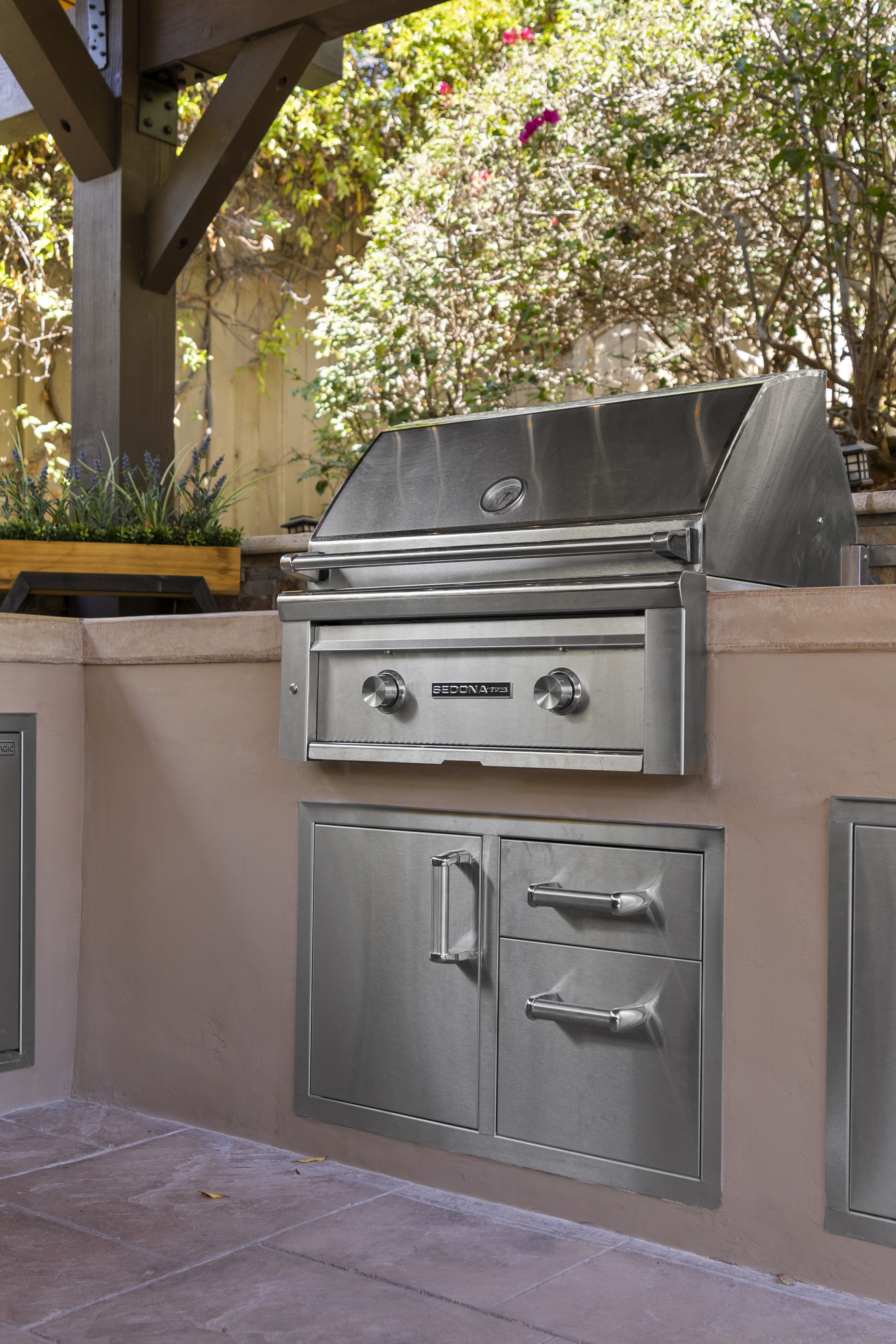 Stainless steel outdoor grill integrated into stucco counter