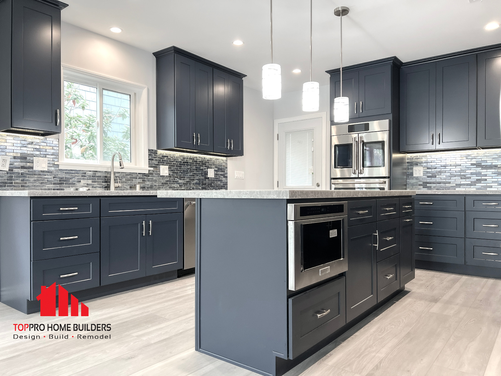 Modern kitchen with pendant lights and marble countertops