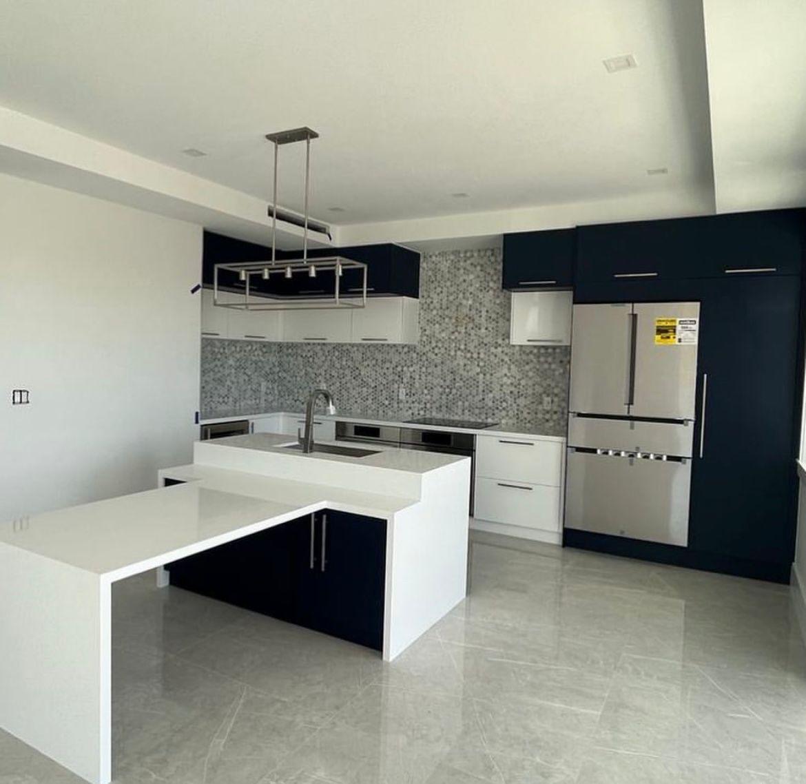 Modern kitchen with central island featuring built-in sink and faucet