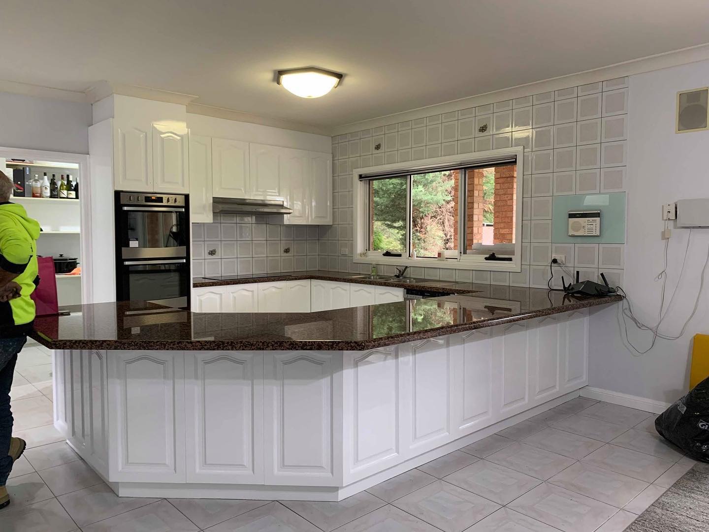 Large kitchen island with dark granite countertop