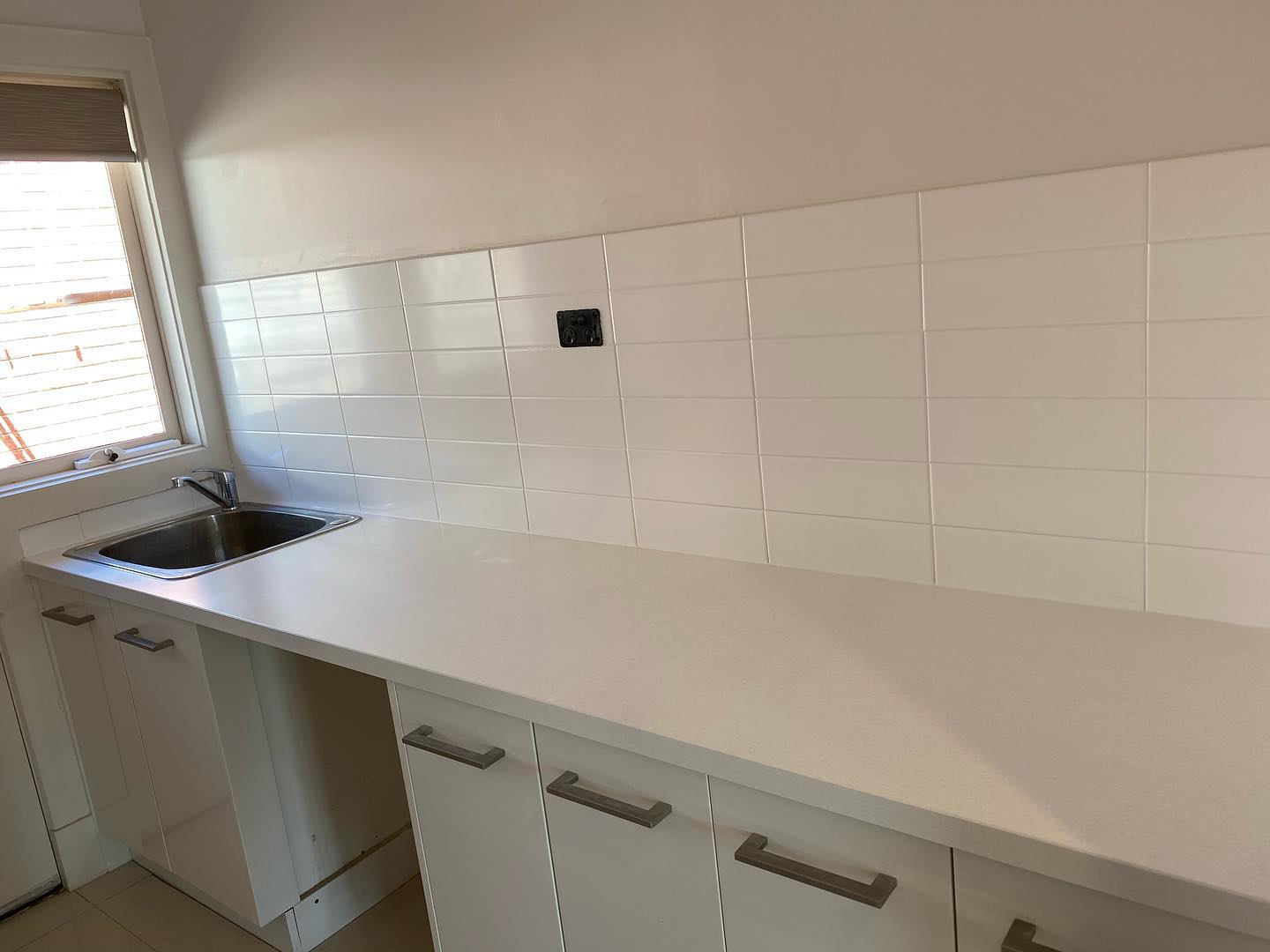 White kitchen cabinets with stainless steel handles