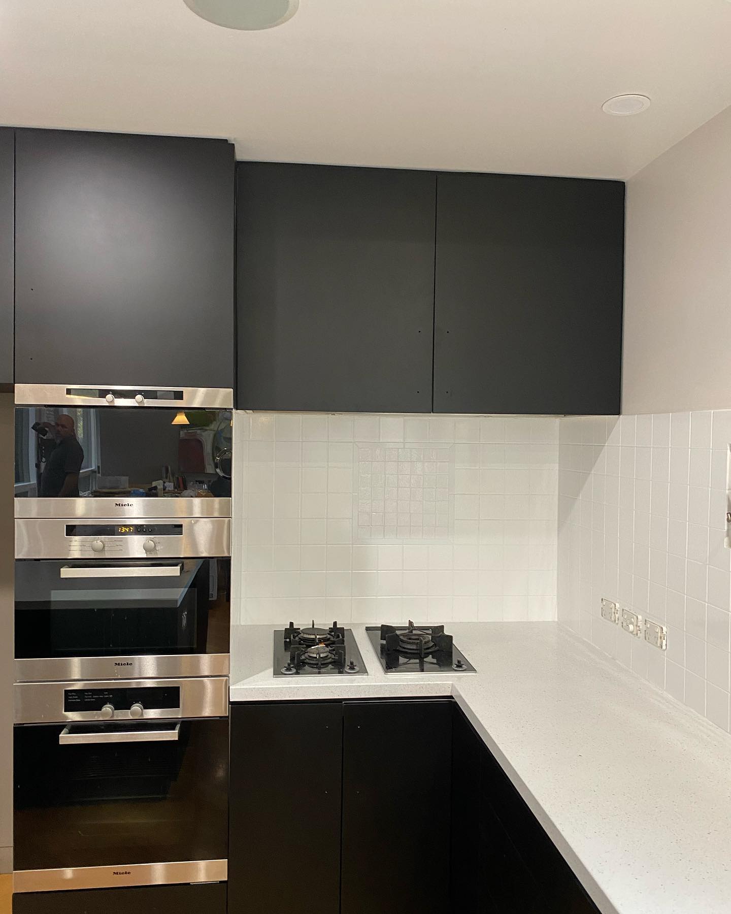 Modern kitchen with black cabinetry and stainless steel appliances