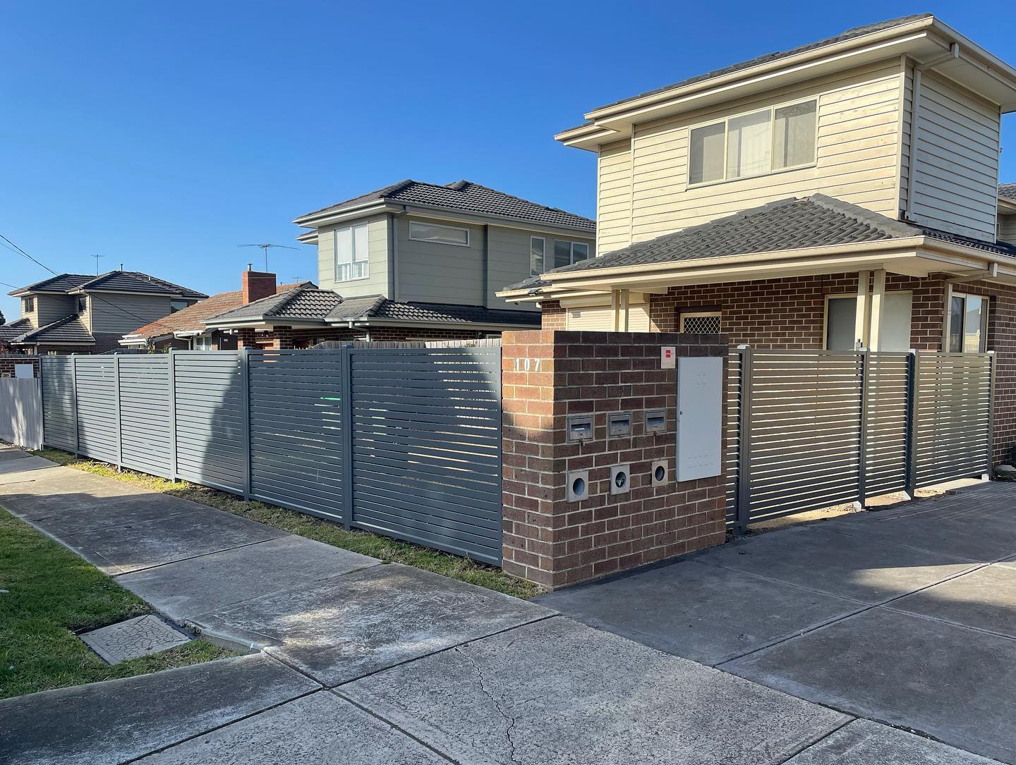 Modern residential house with grey metal fence