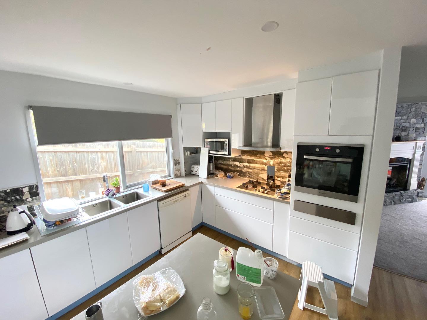 The kitchen features white cabinetry with black handles