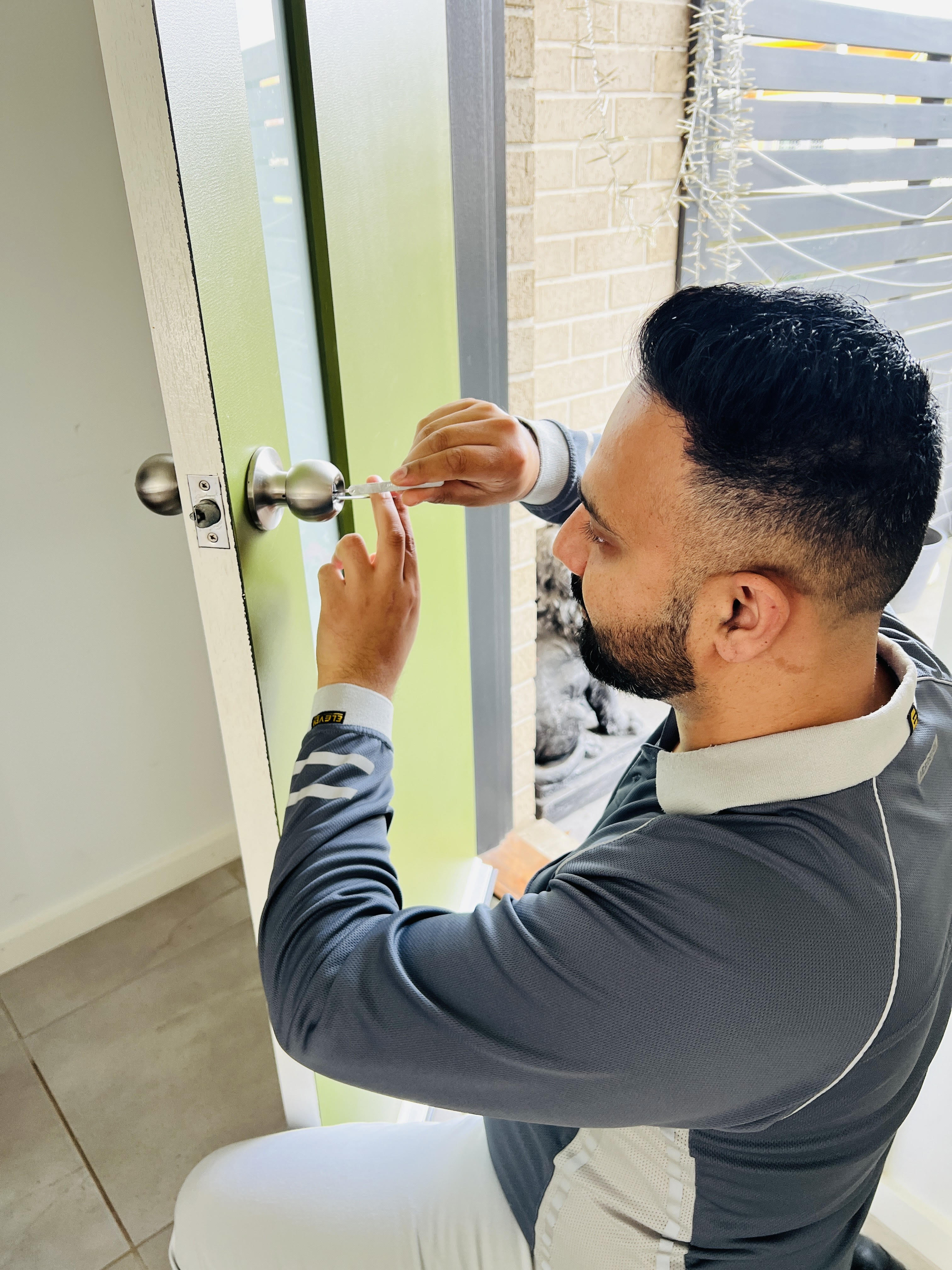 Master locksmith installing a door lock during a lock installation service in Melbourne