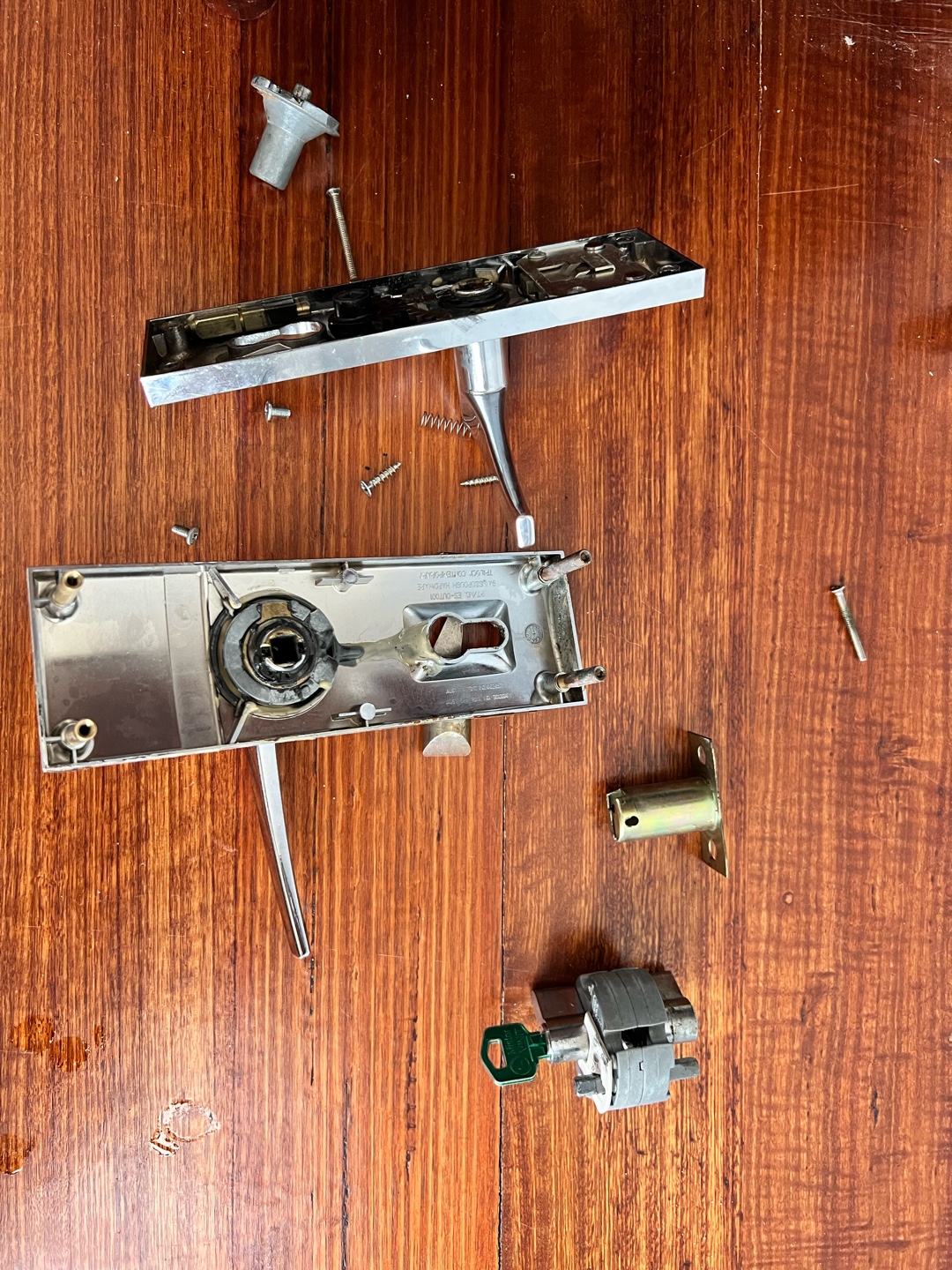 Disassembled lock handle components laid out for inspection