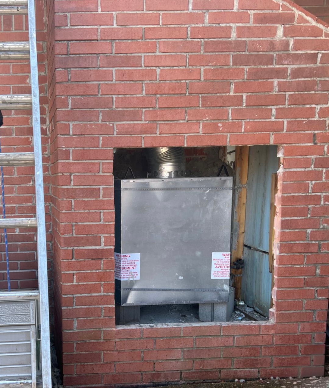Installing a new metal unit within the chimney structure