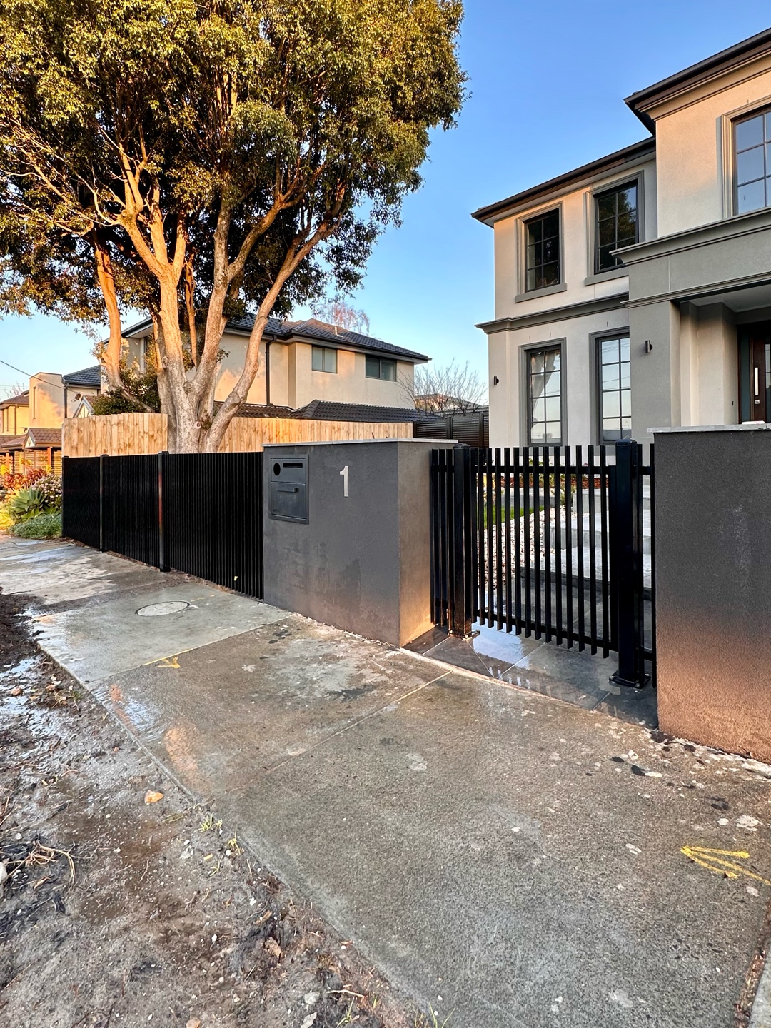 Modern residential property with black metal blade fence