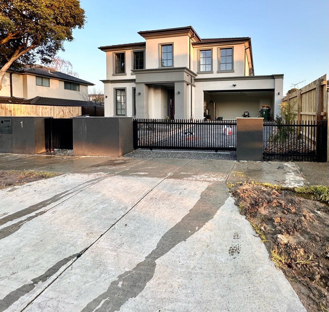 Black metal blade fence with pedestrian gate and auto slider