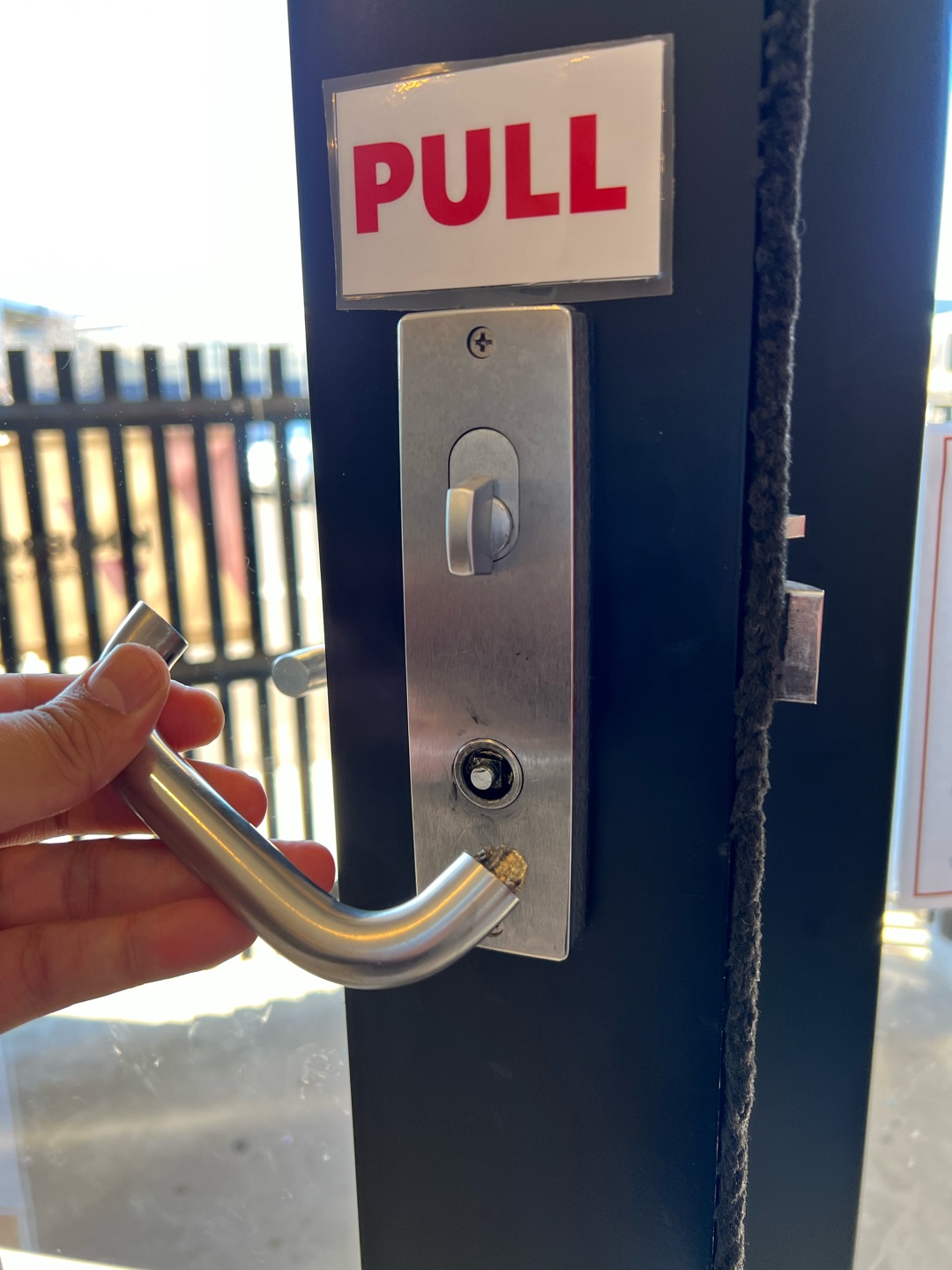 Broken door handle held by hand