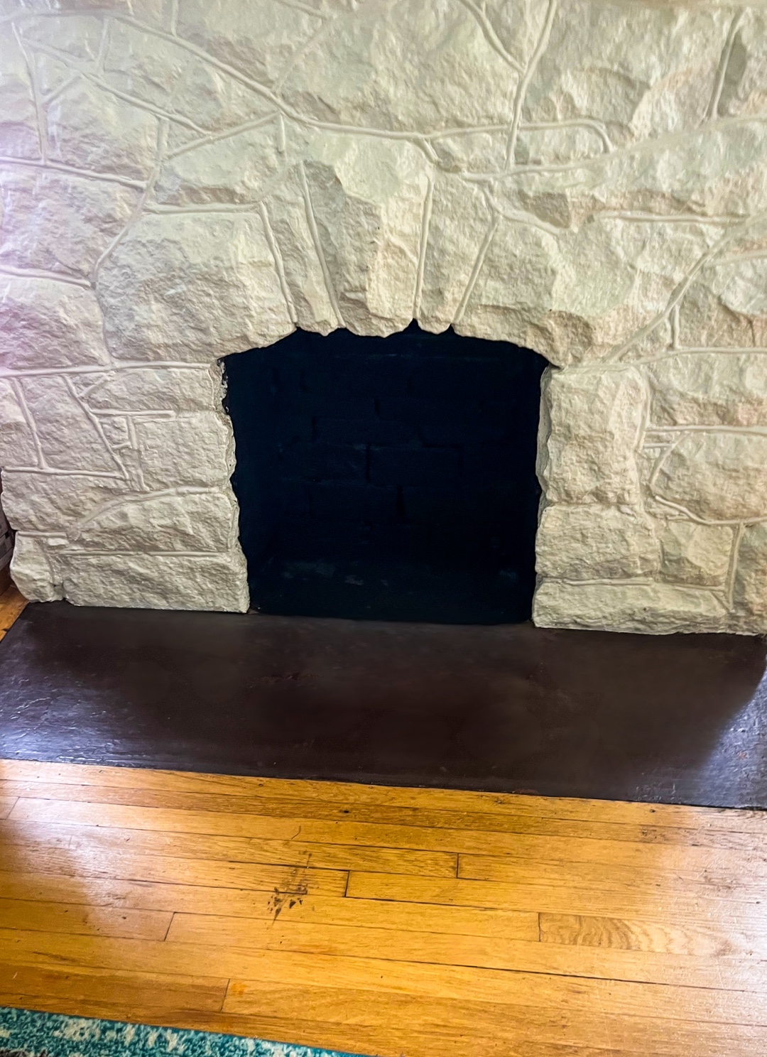 Capped gas line in stone facade fireplace