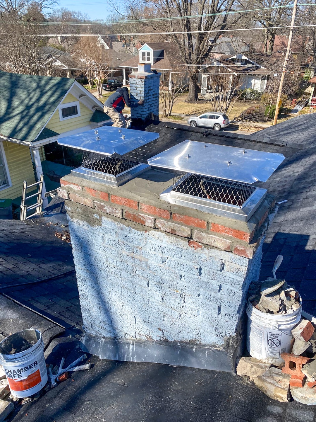 Foreground chimney with new stainless steel caps installed