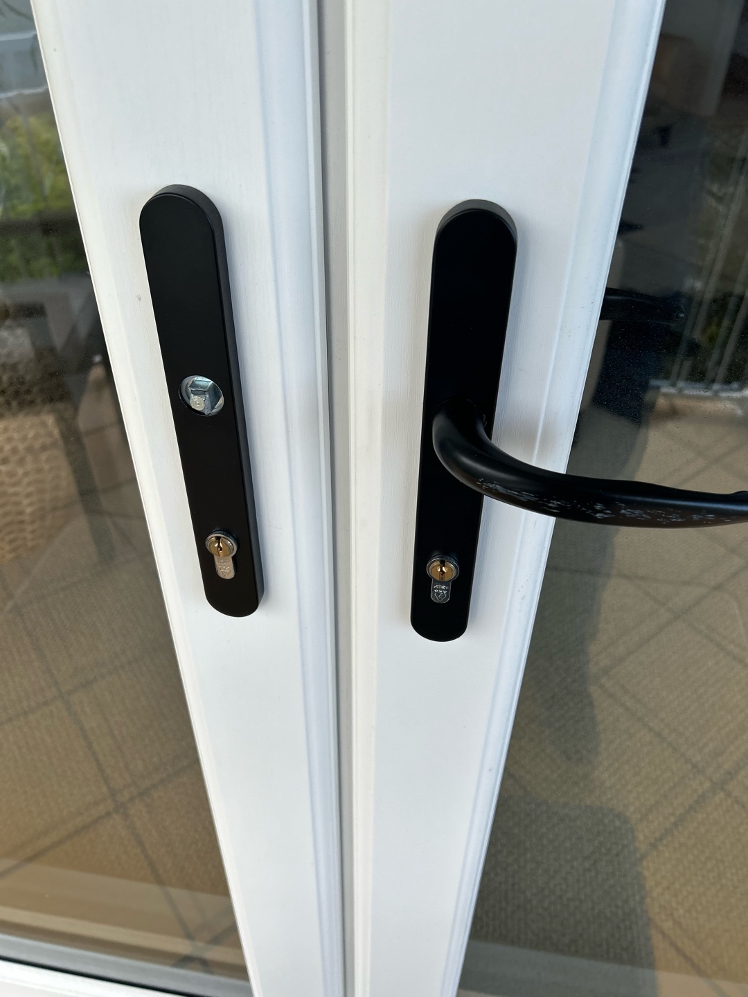 Broken door lock handle on white double doors