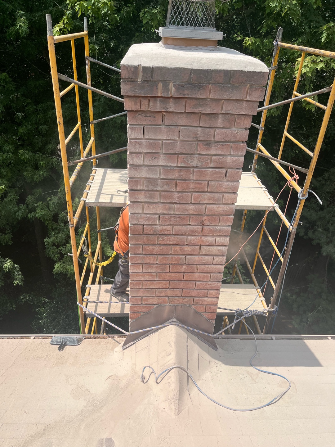 Brick chimney with newly installed crown and mount cap