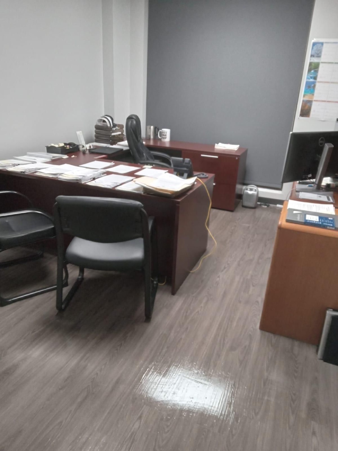 Before cleaning: An office desk cluttered with papers in need of Delta Janitorial's touch