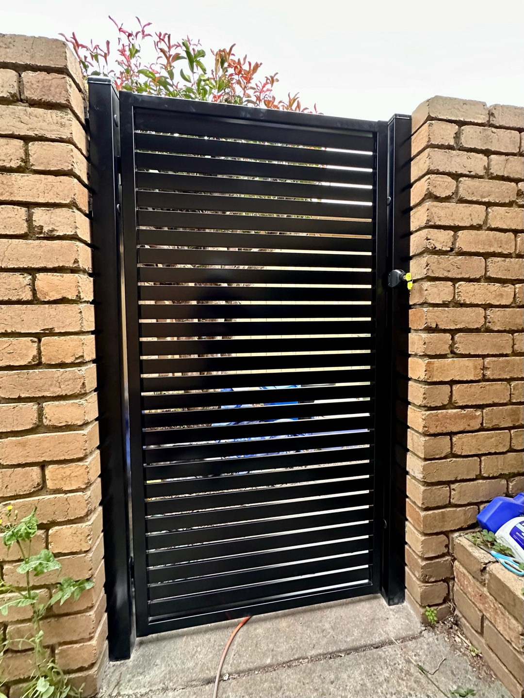 Pedestrian gate framed by brick pillars