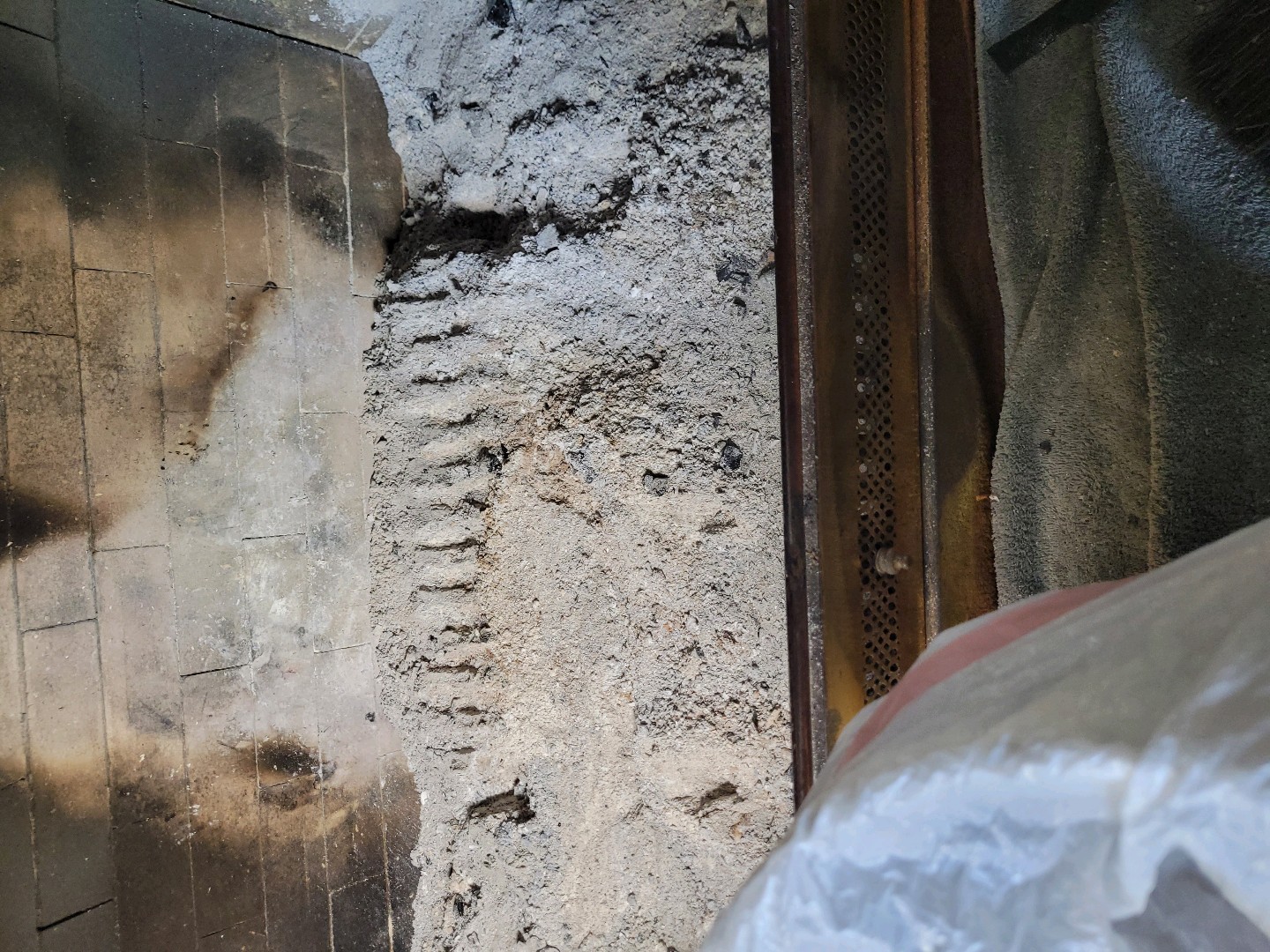 Accumulation of ash and debris inside a fireplace
