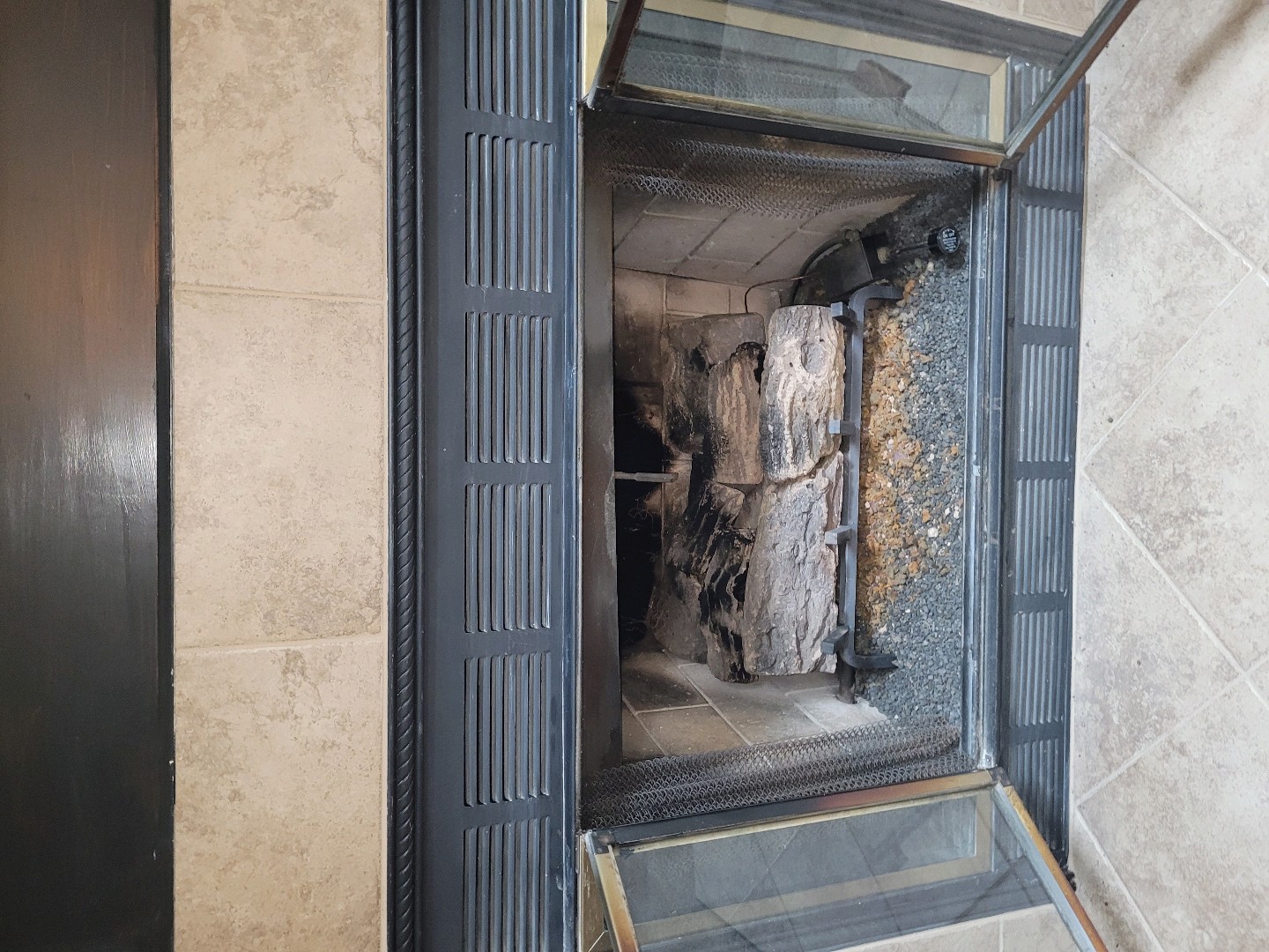 Gas fireplace with glass doors open