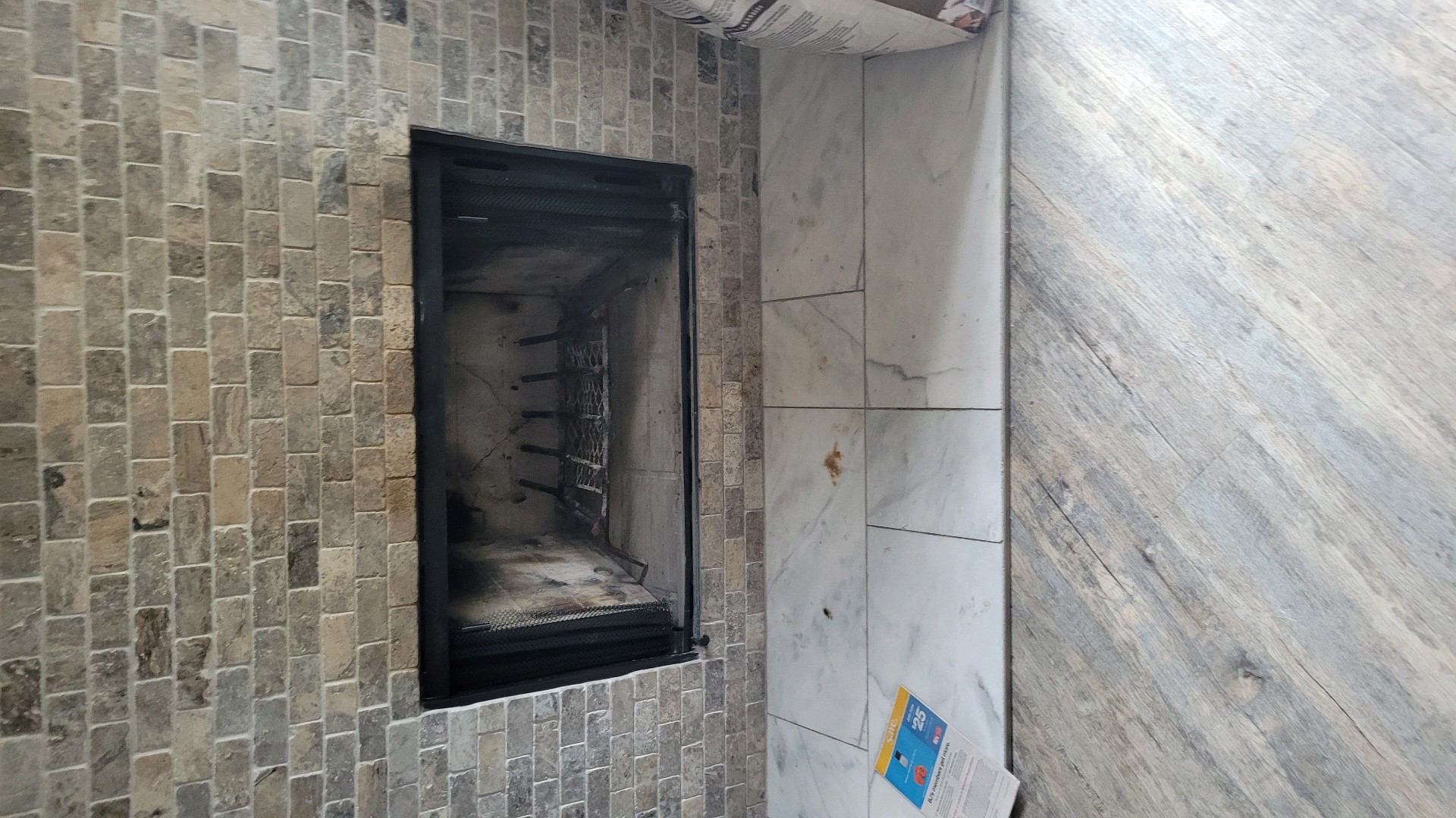 Fireplace with a brick surround and a black metal frame