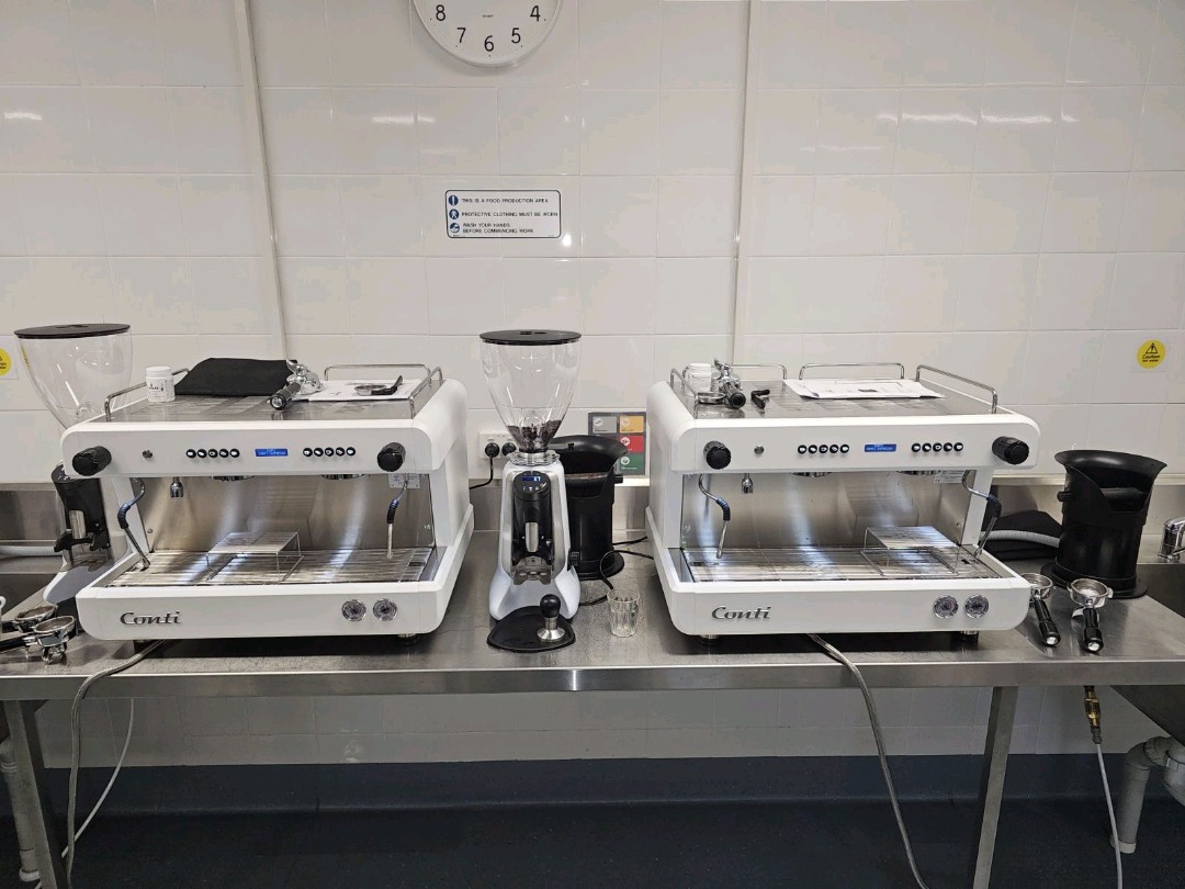 Two Conti espresso machines installed side by side with CG200 grinders.