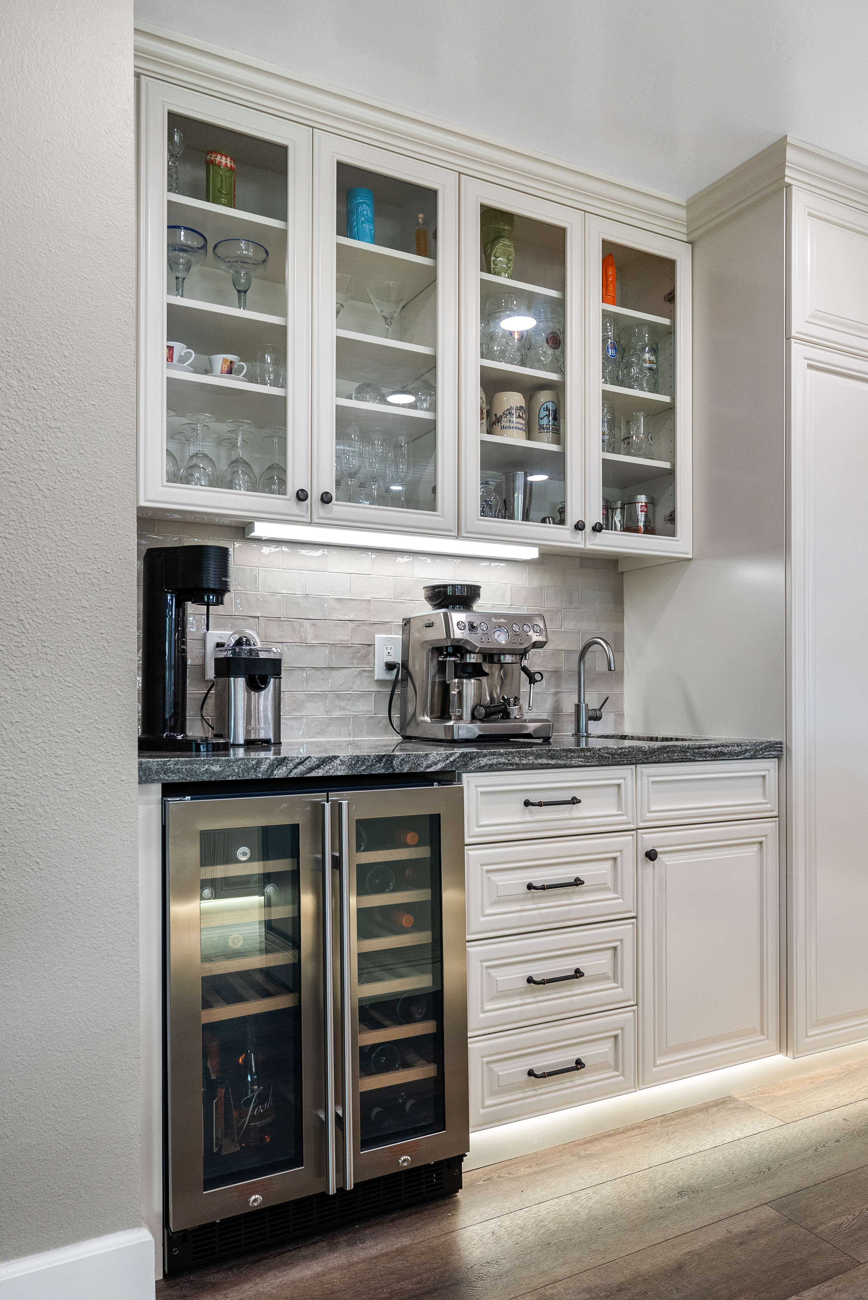 Coffee station with upper cabinets displaying glassware