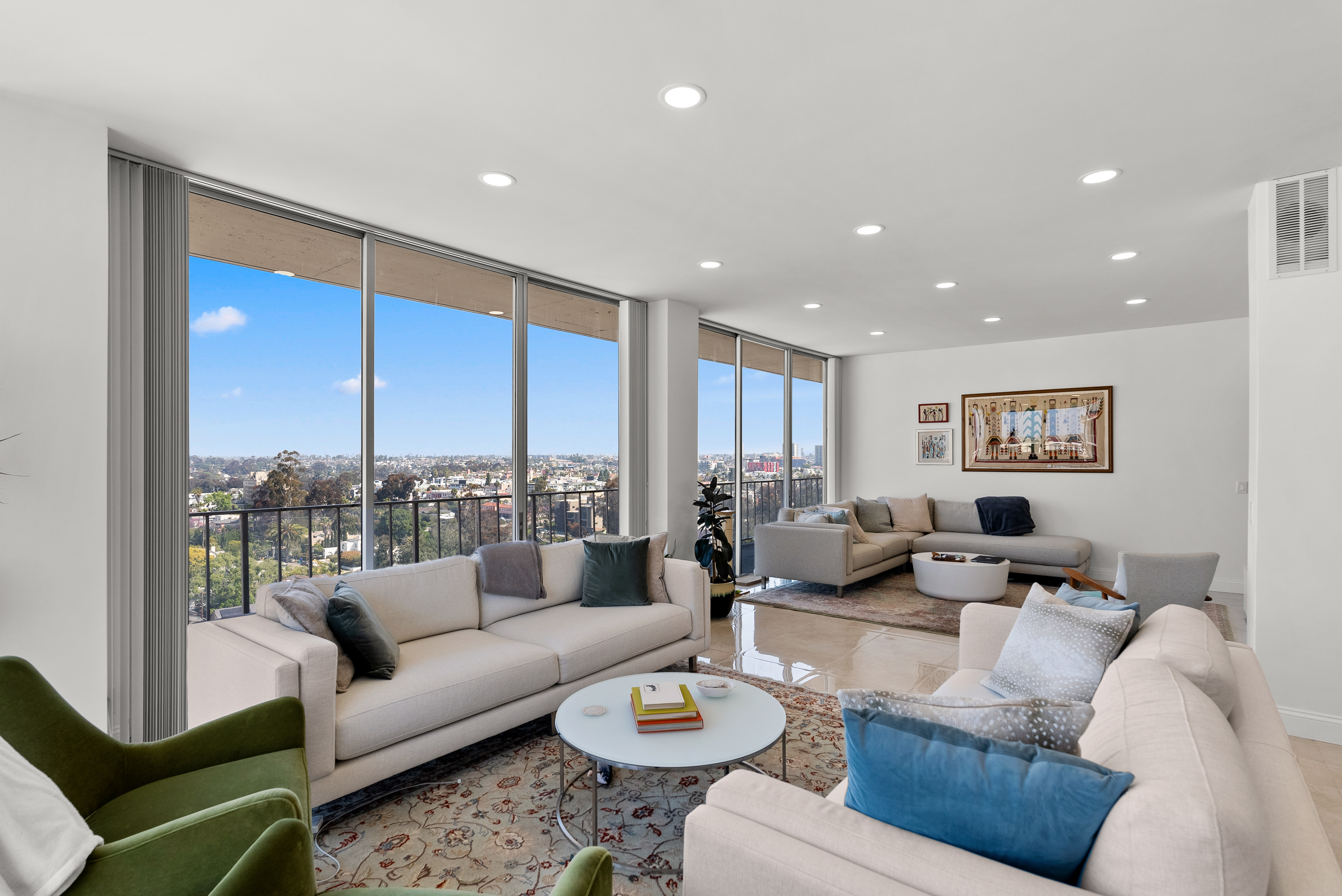 Modern living room featuring large windows and neutral color palette