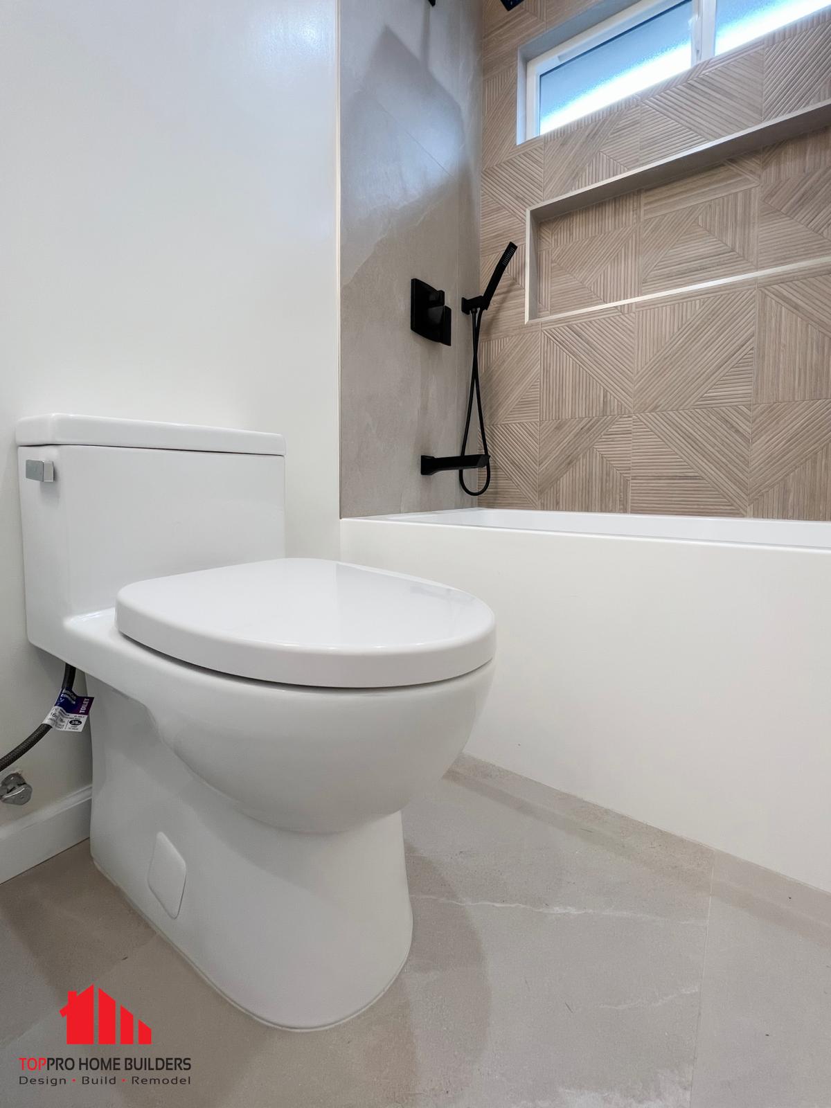 Modern white toilet on light-colored tiled floor