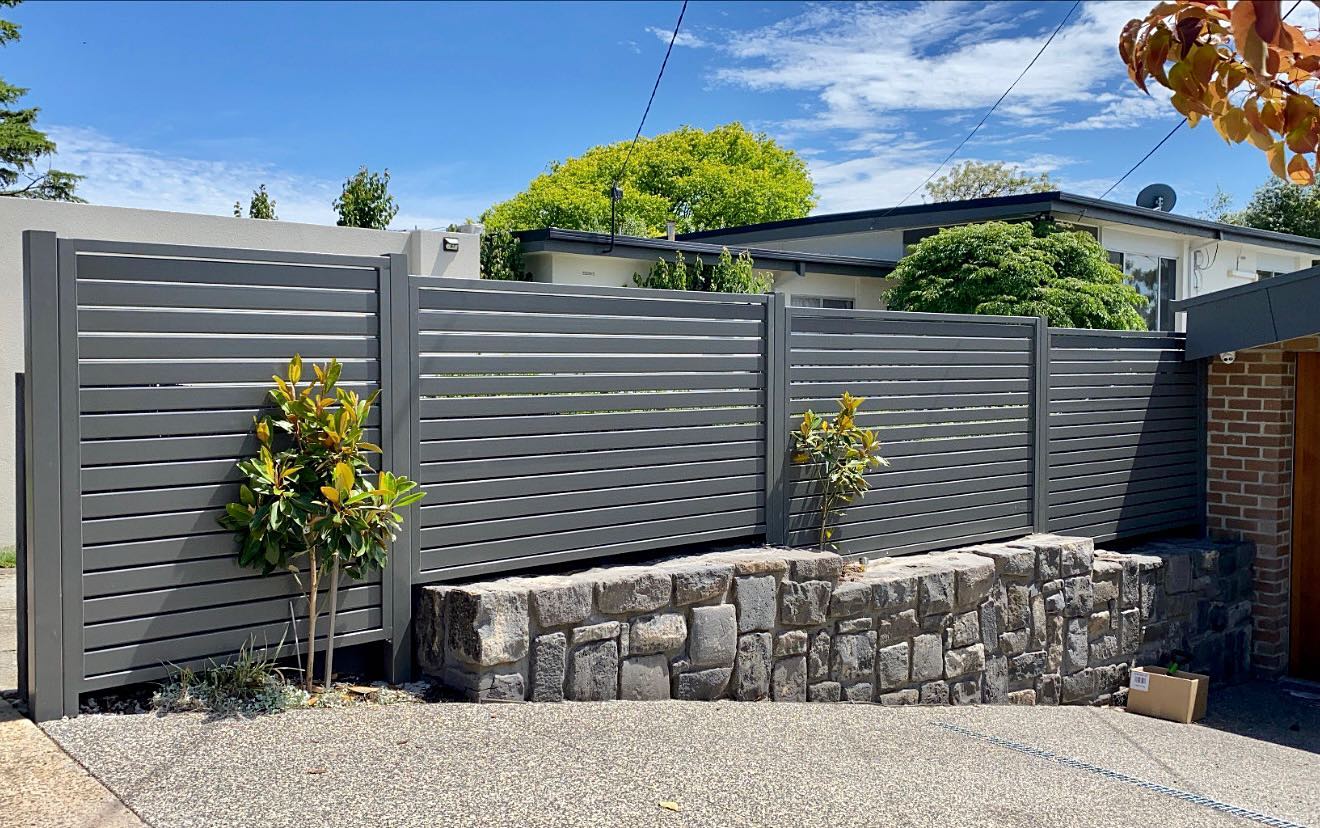Transforming Boundaries: Expert Advice on Style and Color for a Rewarding Home Upgrade in Essendon North 2 Stylish three-panel horizontal slat fence with stone retaining wall