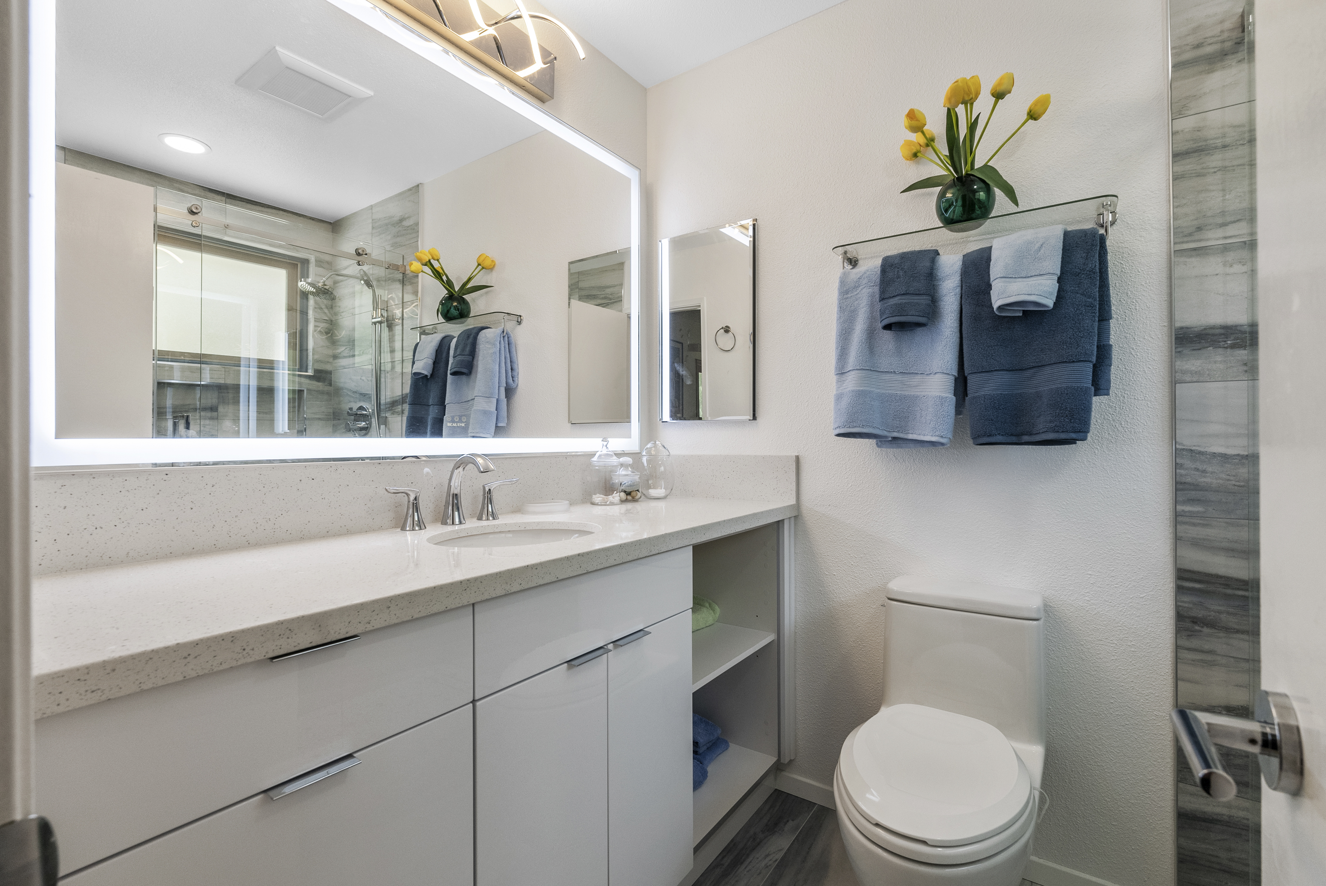 Modern bathroom featuring custom shower area