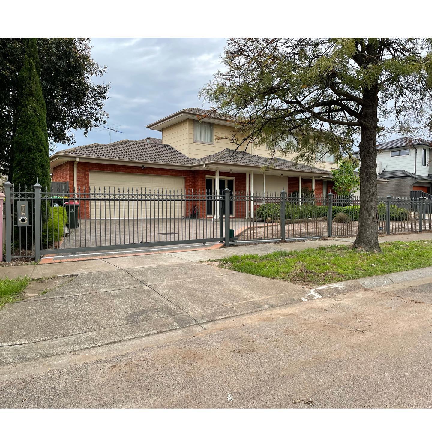 Black metal security gate with vertical bars