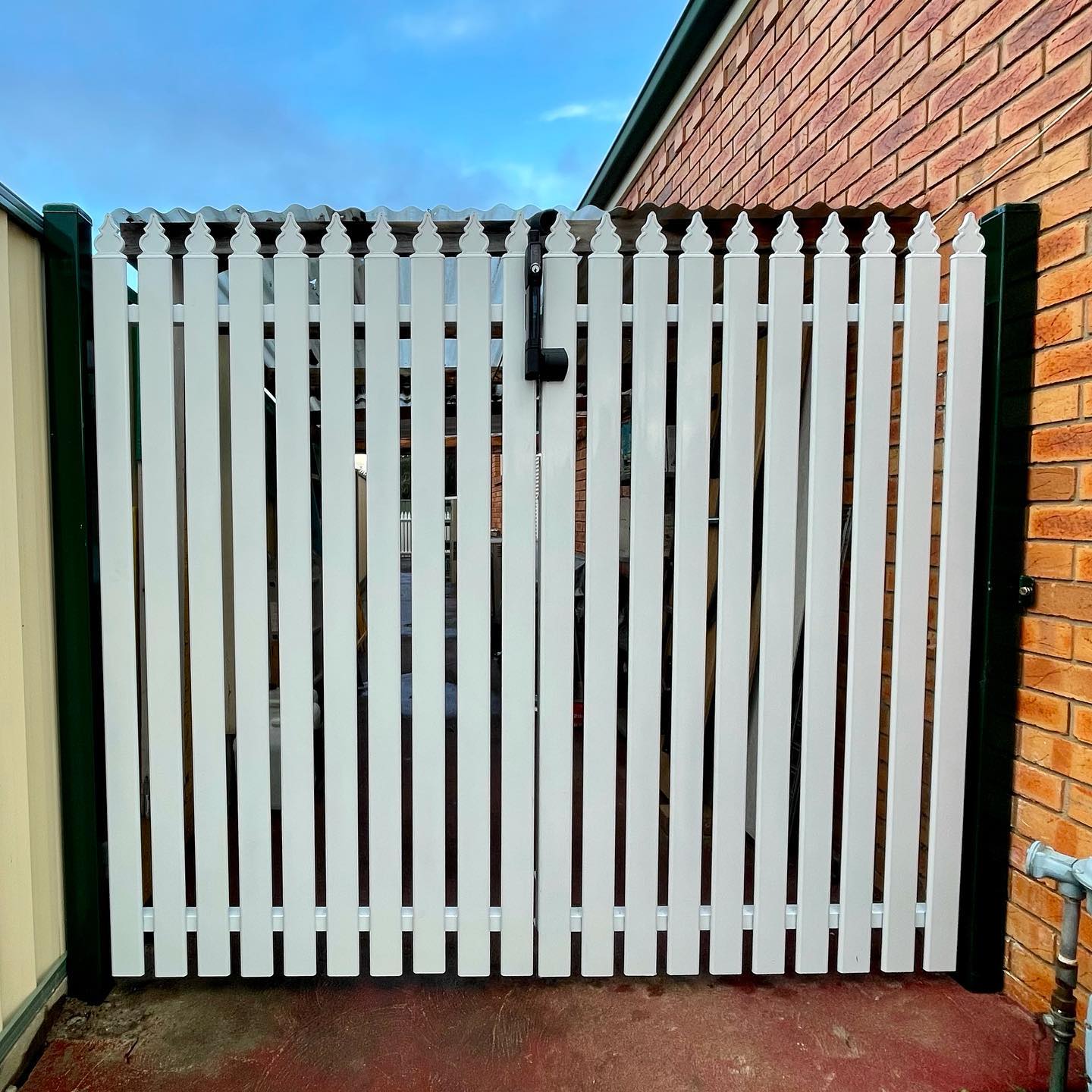 White metal picket fence with decorative pointed tips