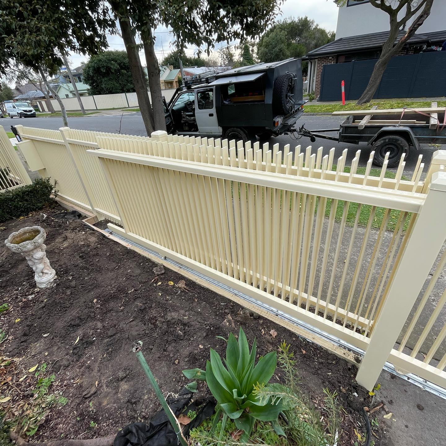 Beige vertical picket fence newly installed