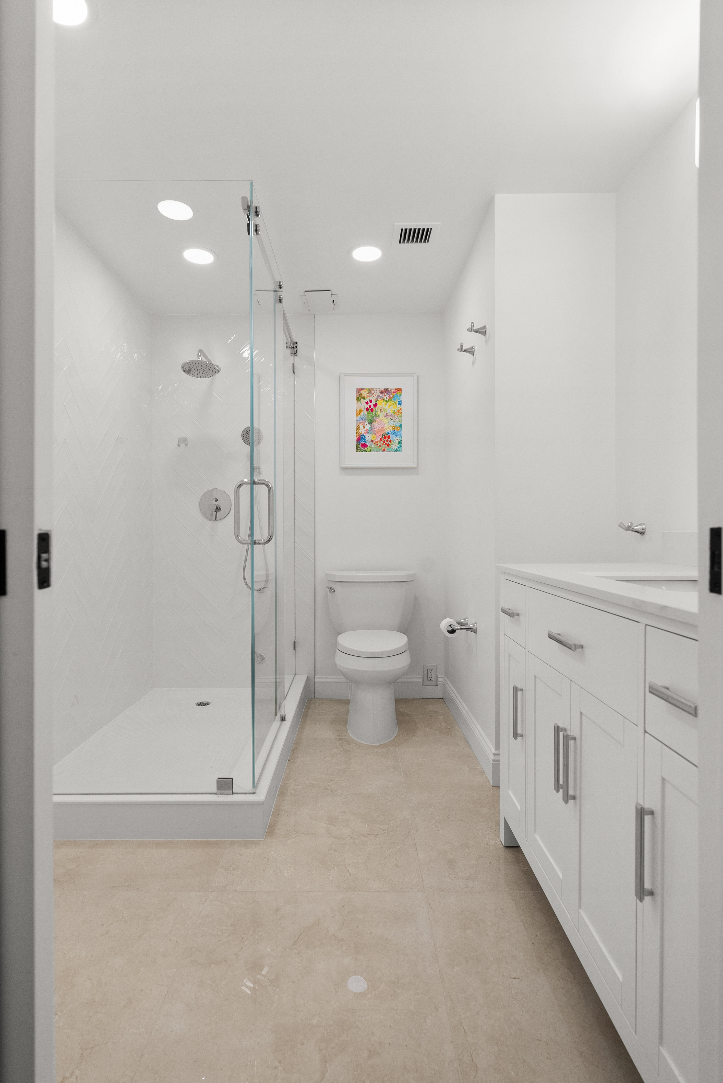 Modern bathroom featuring glass-enclosed shower area