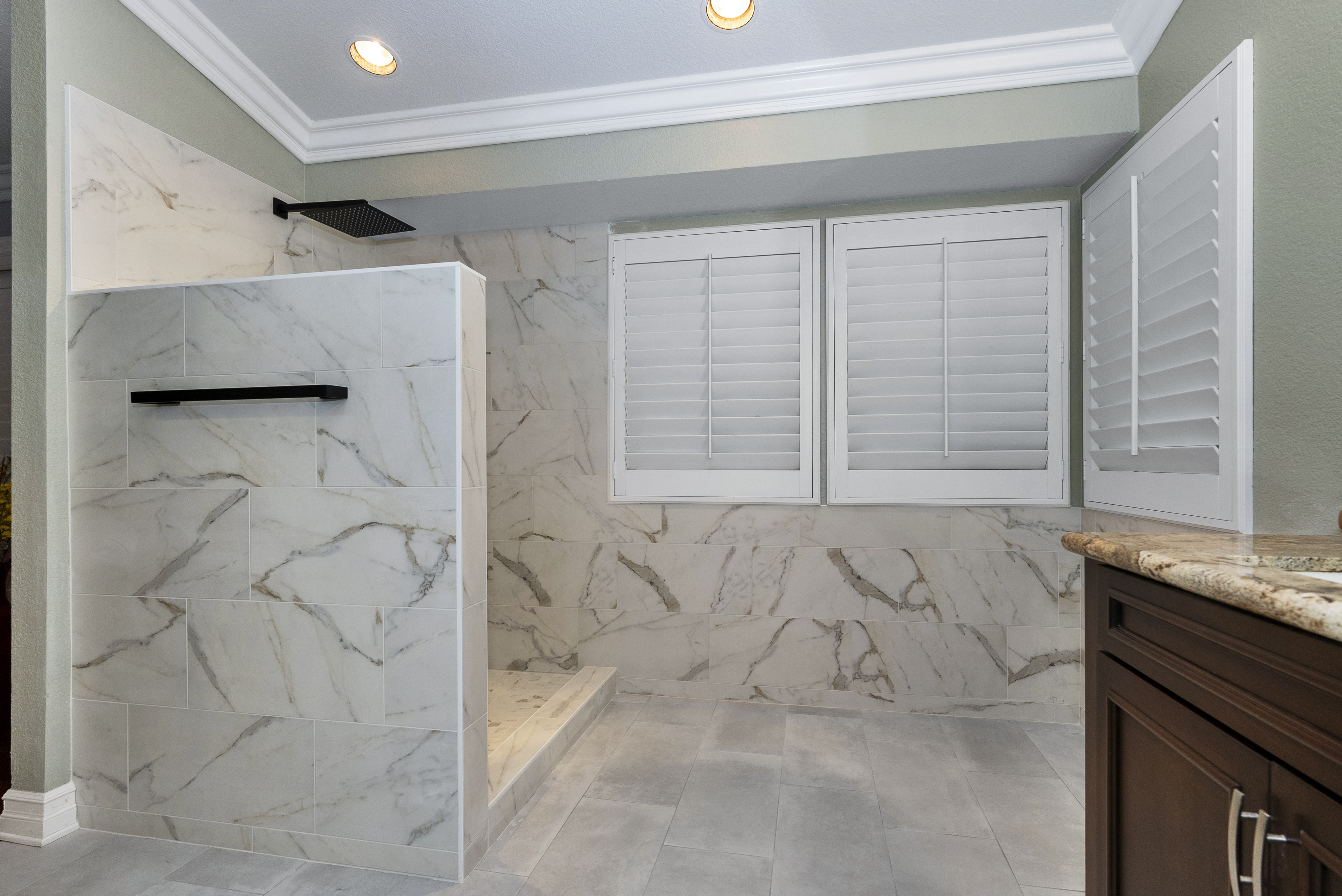 Modern bathroom featuring marble tile walls and flooring