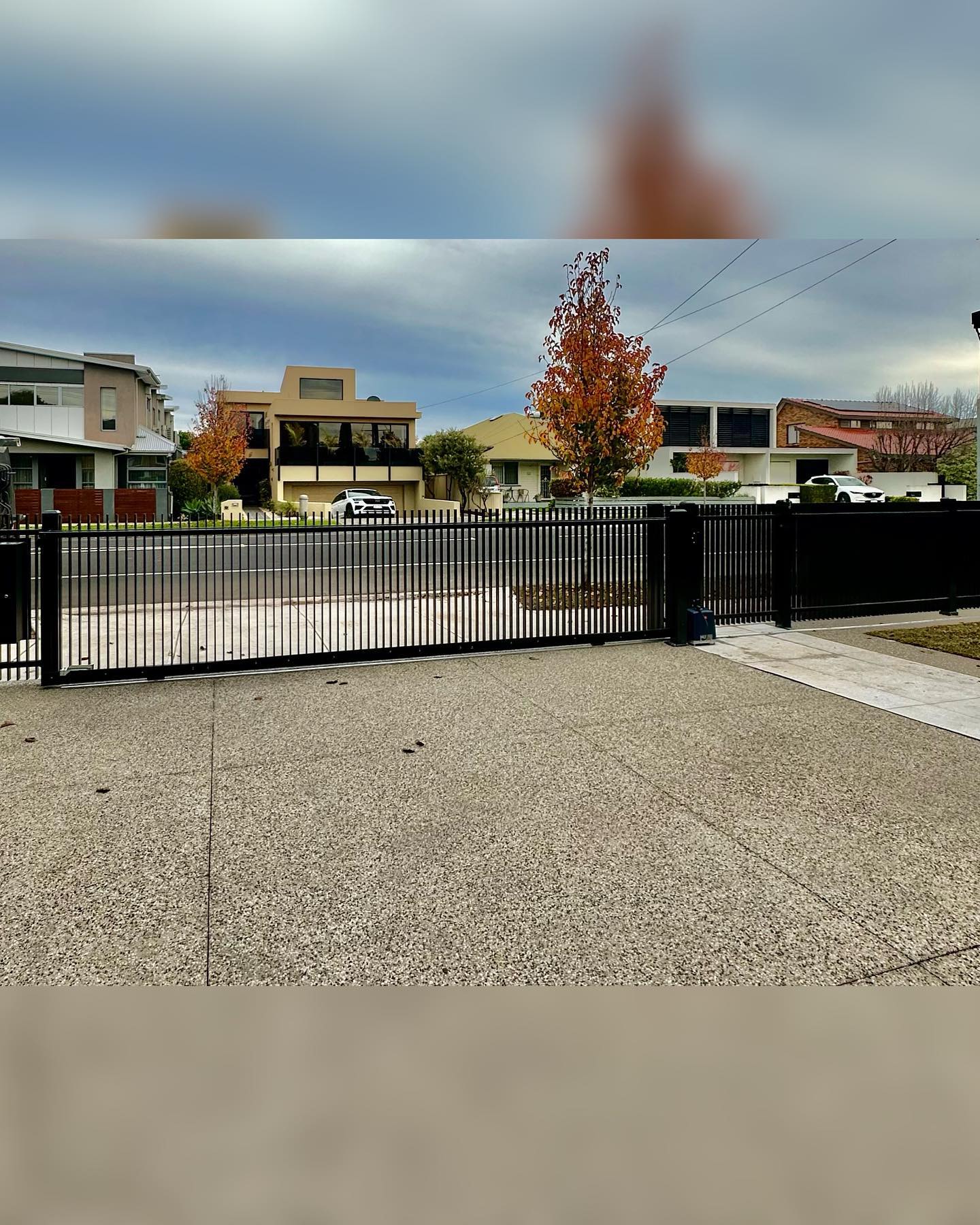 Satin Black Blade Style Fence Installation in Altona North 3 Residential neighborhood setting with modern homes in the background