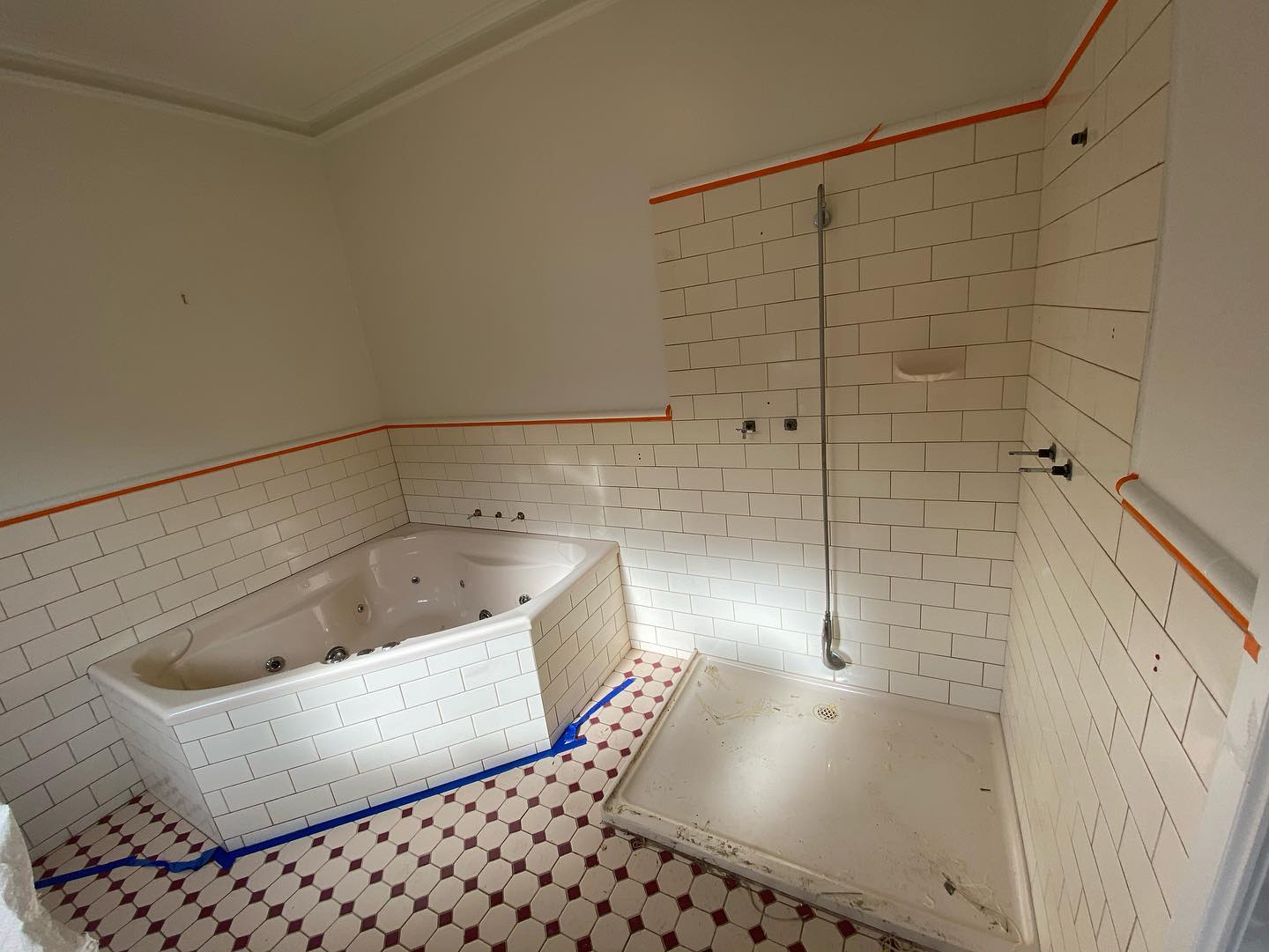 Bathroom under renovation with white bathtub and subway tiles