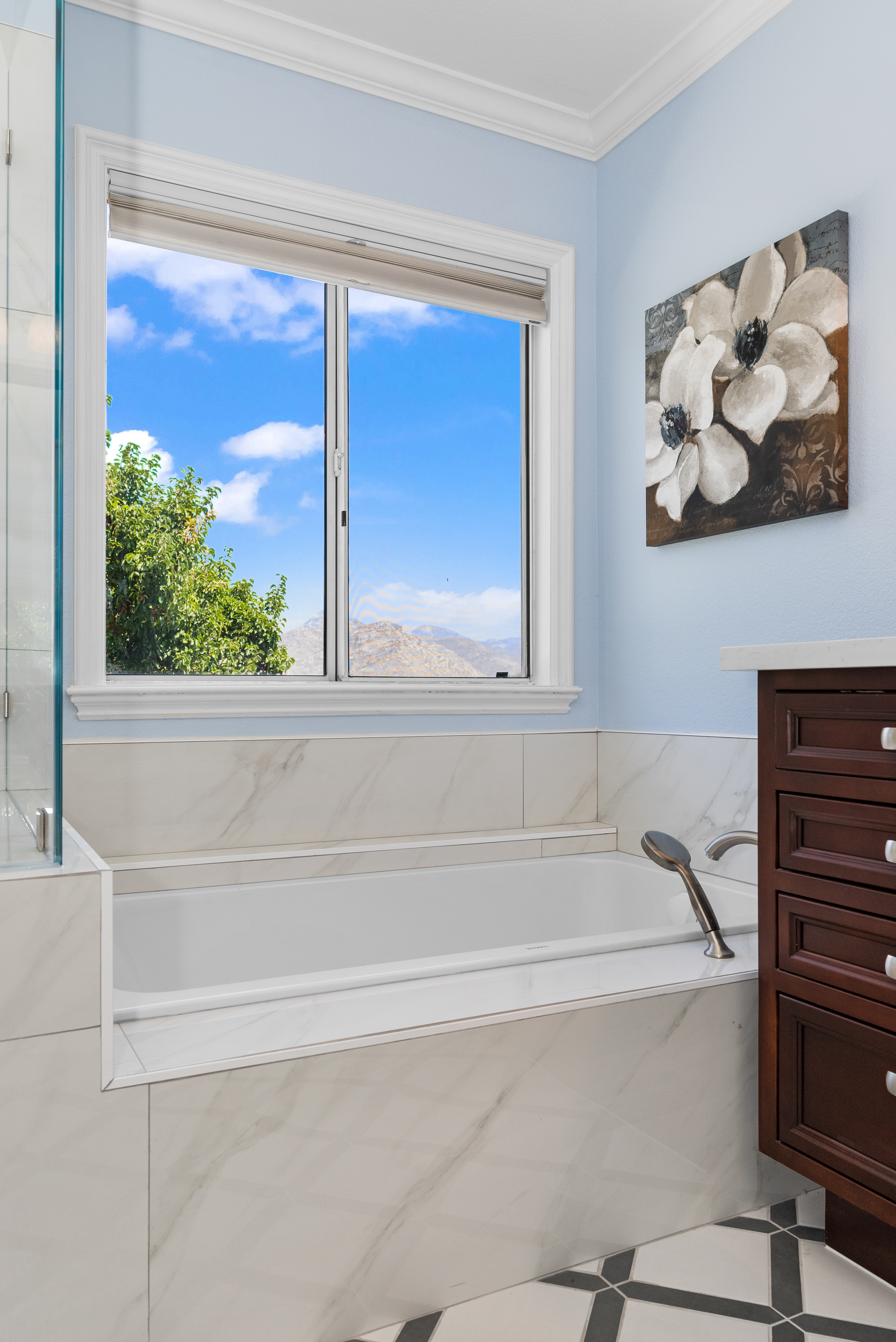 Luxurious bathtub surrounded by marble-like tiles