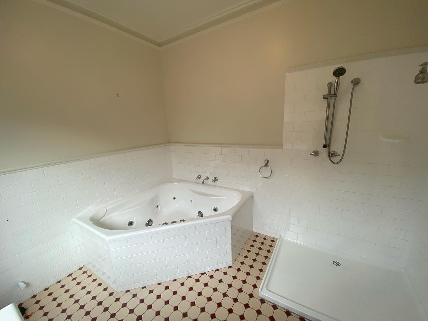 Completed bathroom with white corner bathtub
