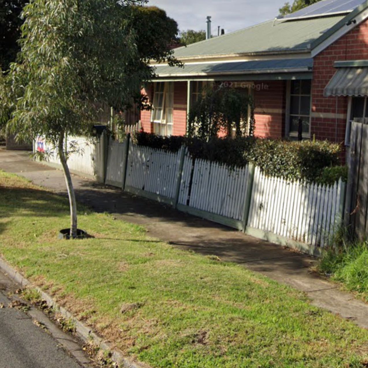 White picket fence in disrepair
