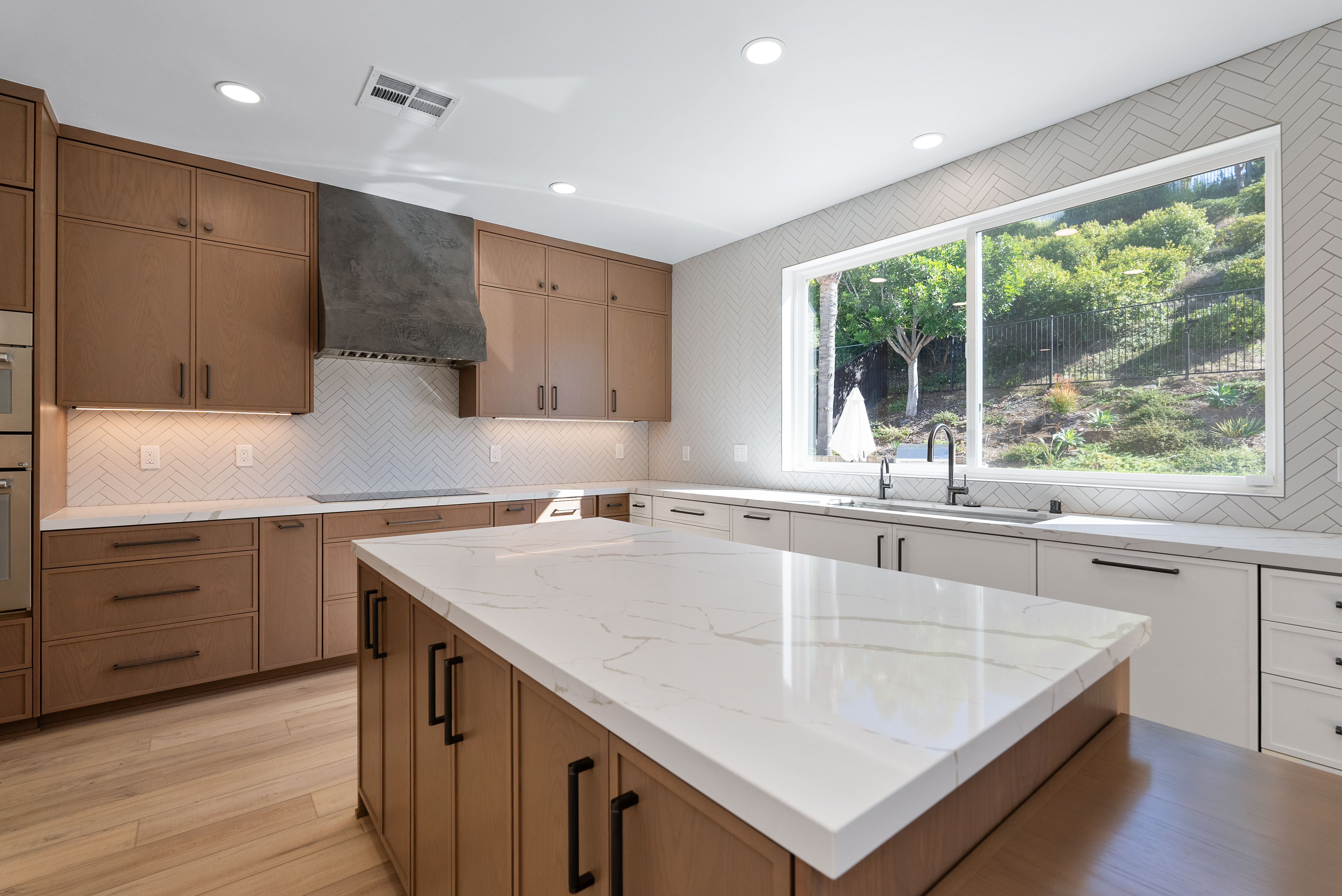 Modern kitchen with white marble countertop and wooden cabinetry