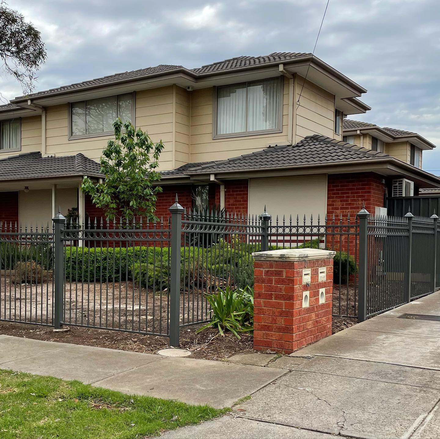 Residential property surrounded by classic ring and spears tubular fence