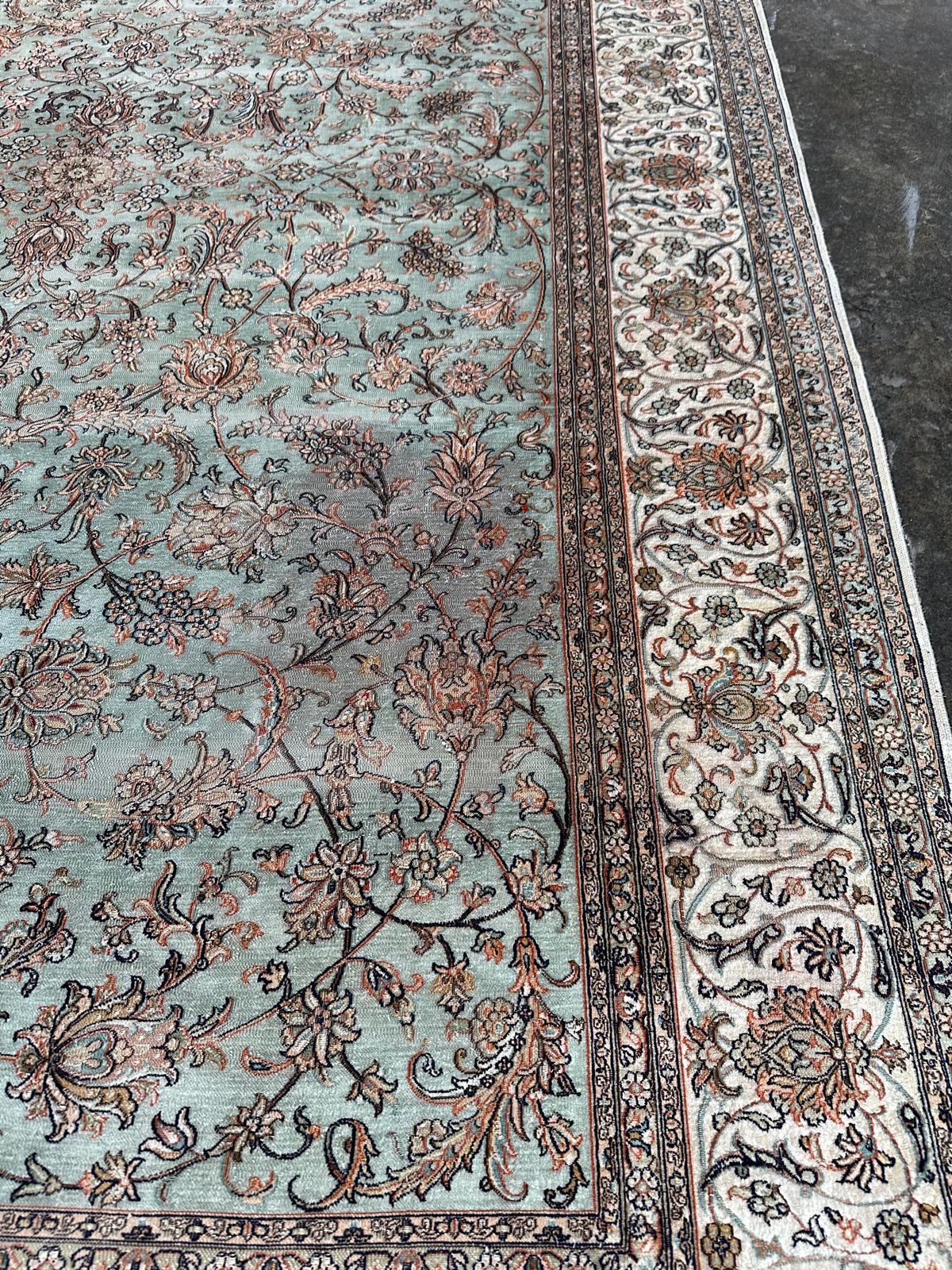 Intricate floral patterns on a silk rug