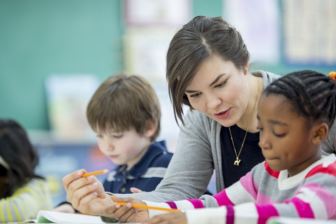 Teacher engaging one-on-one with a student during classwork