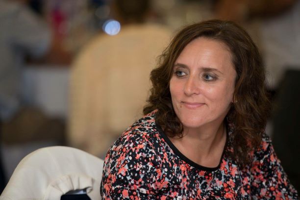 Headteacher Shonogh Pilgrim engaged in thoughtful conversation at an event.