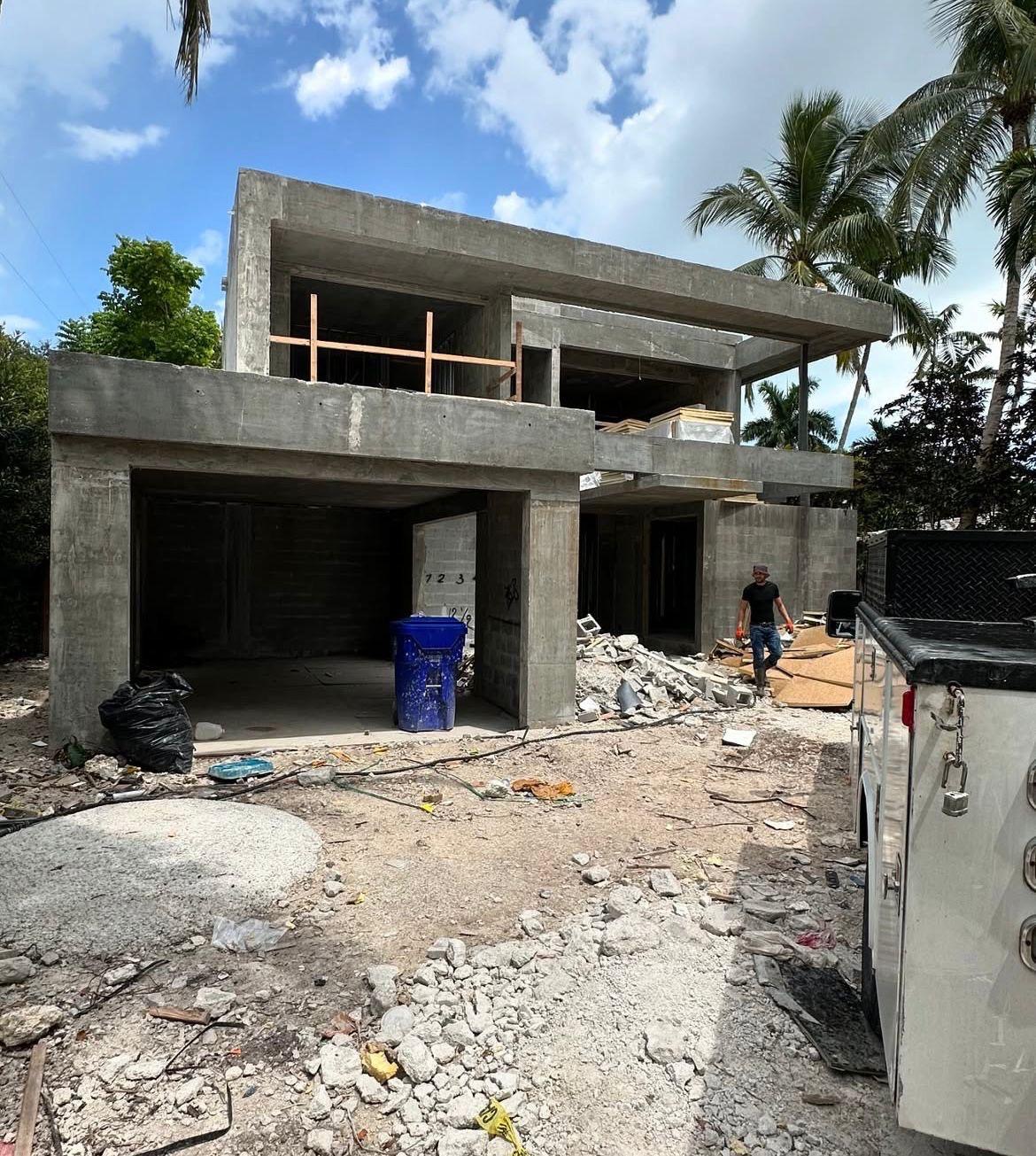 A modern concrete house under construction with a flat roof design