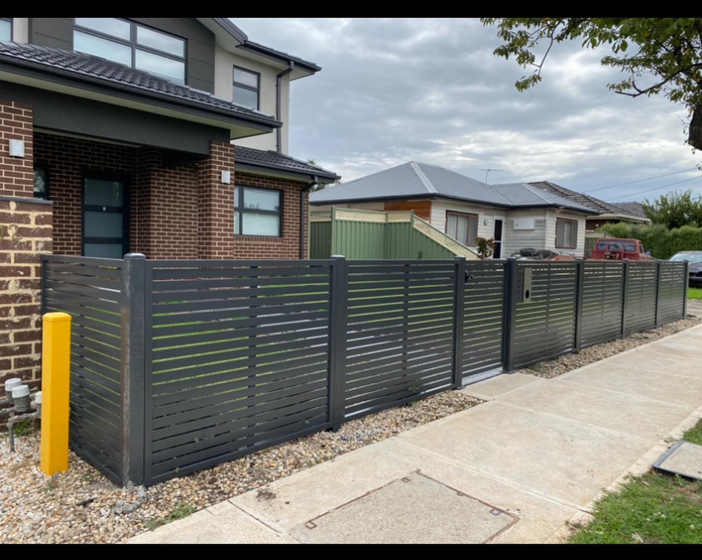 Monument Finished 50x10 Slat Screen Fence and Pedestrian Gate in Lalor 3 Modern house with newly installed 50x10 slat screen fence