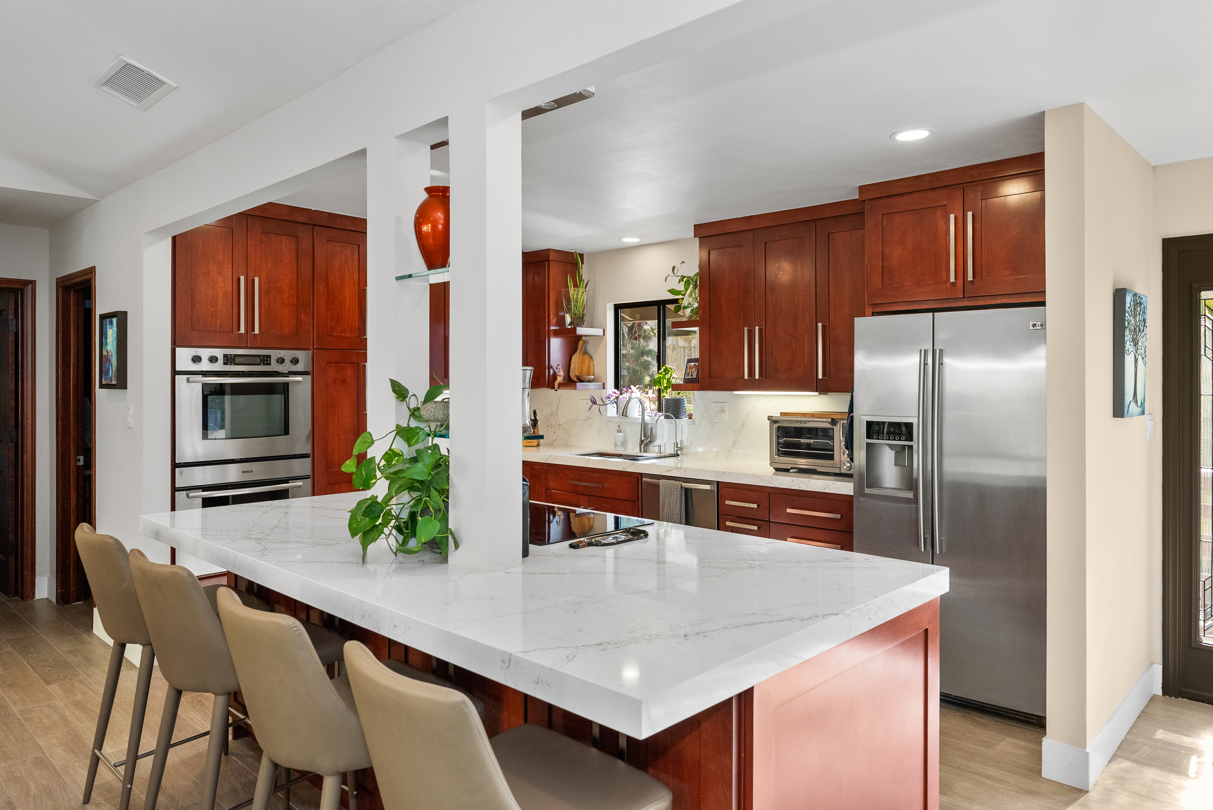 Modern kitchen with cherry wood cabinets and stainless steel appliances