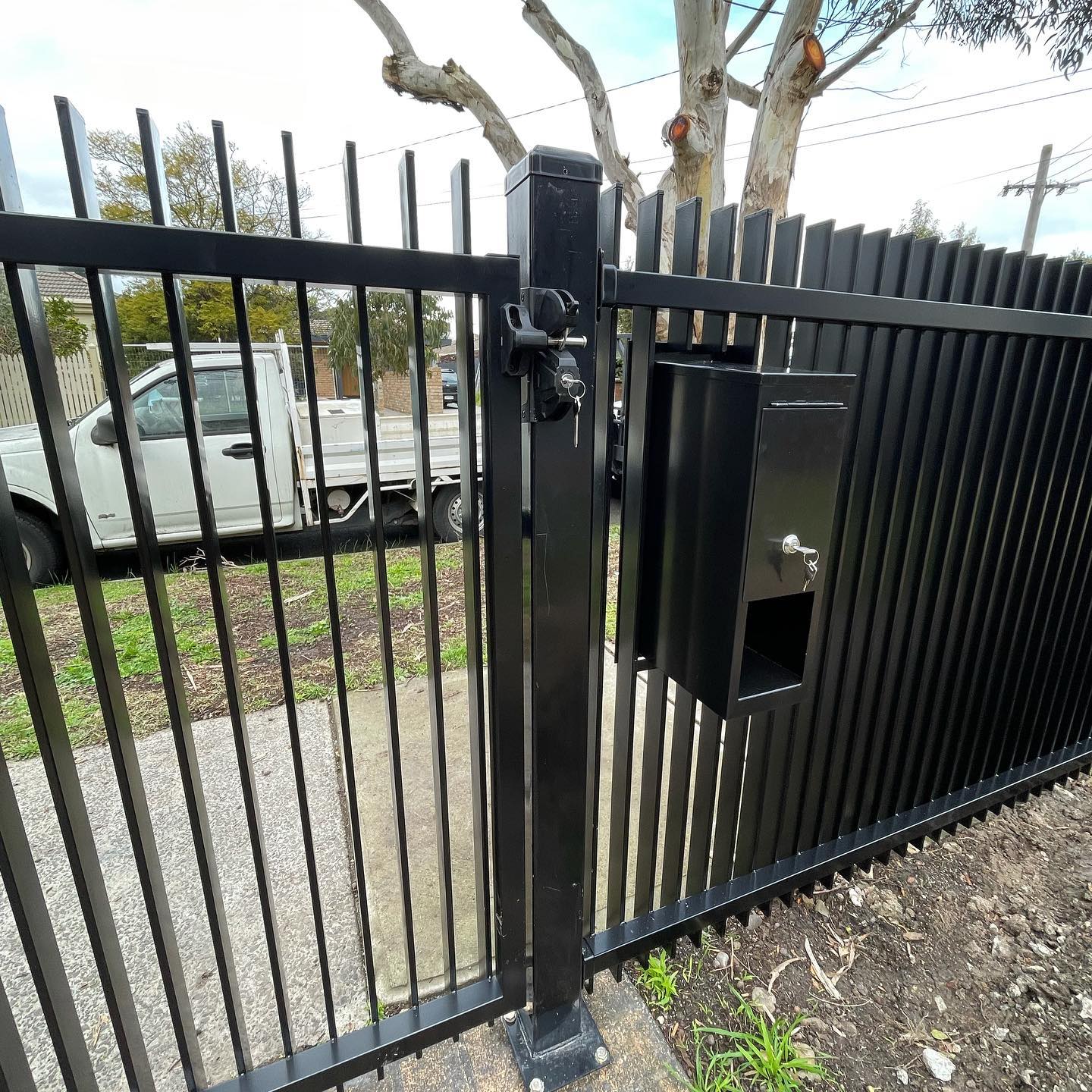 Black metal fence with lock mechanism